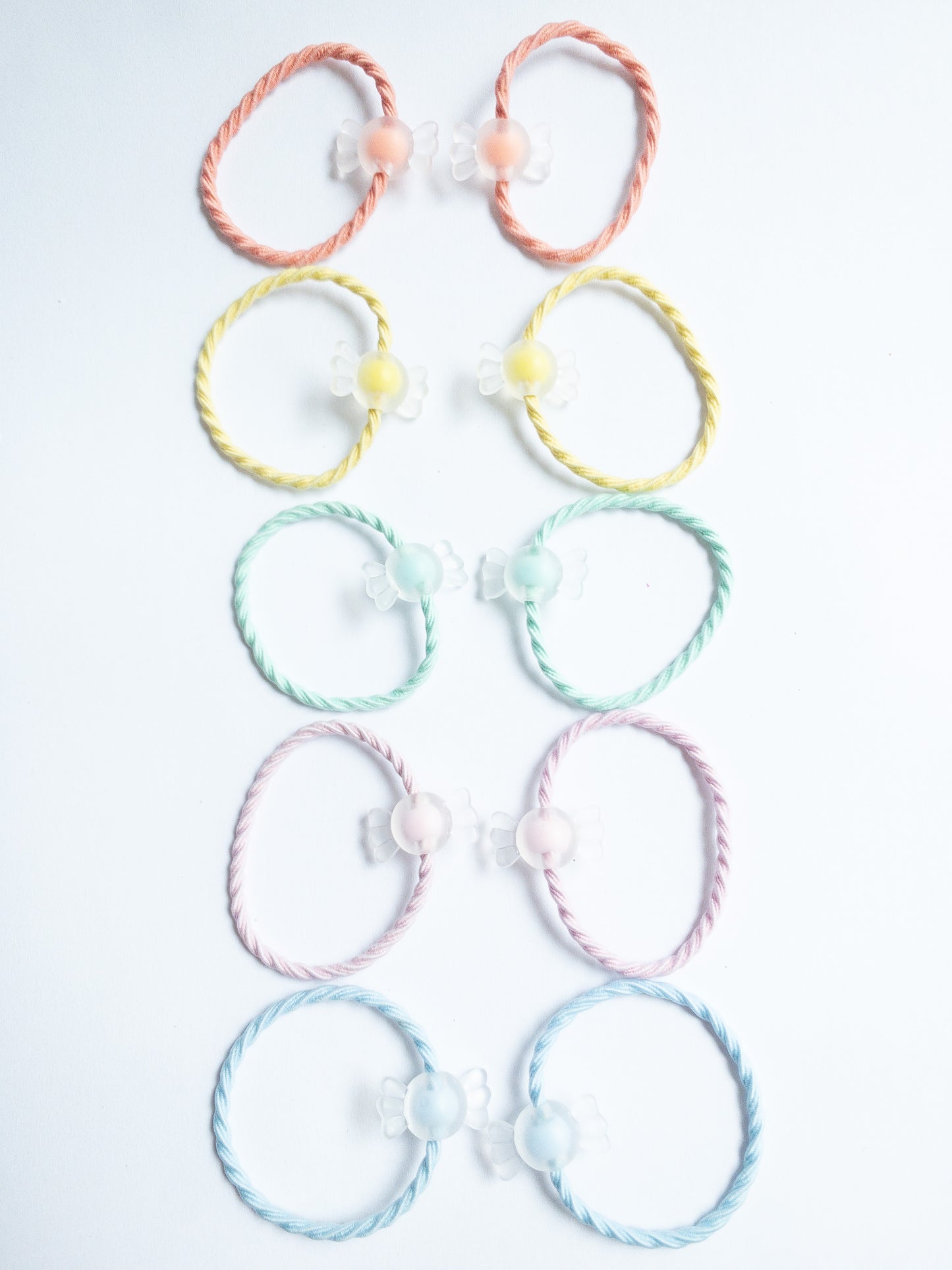 Cute little milky yogurt candies on fabric soft hair ties. Each set contains 10 hair ties.