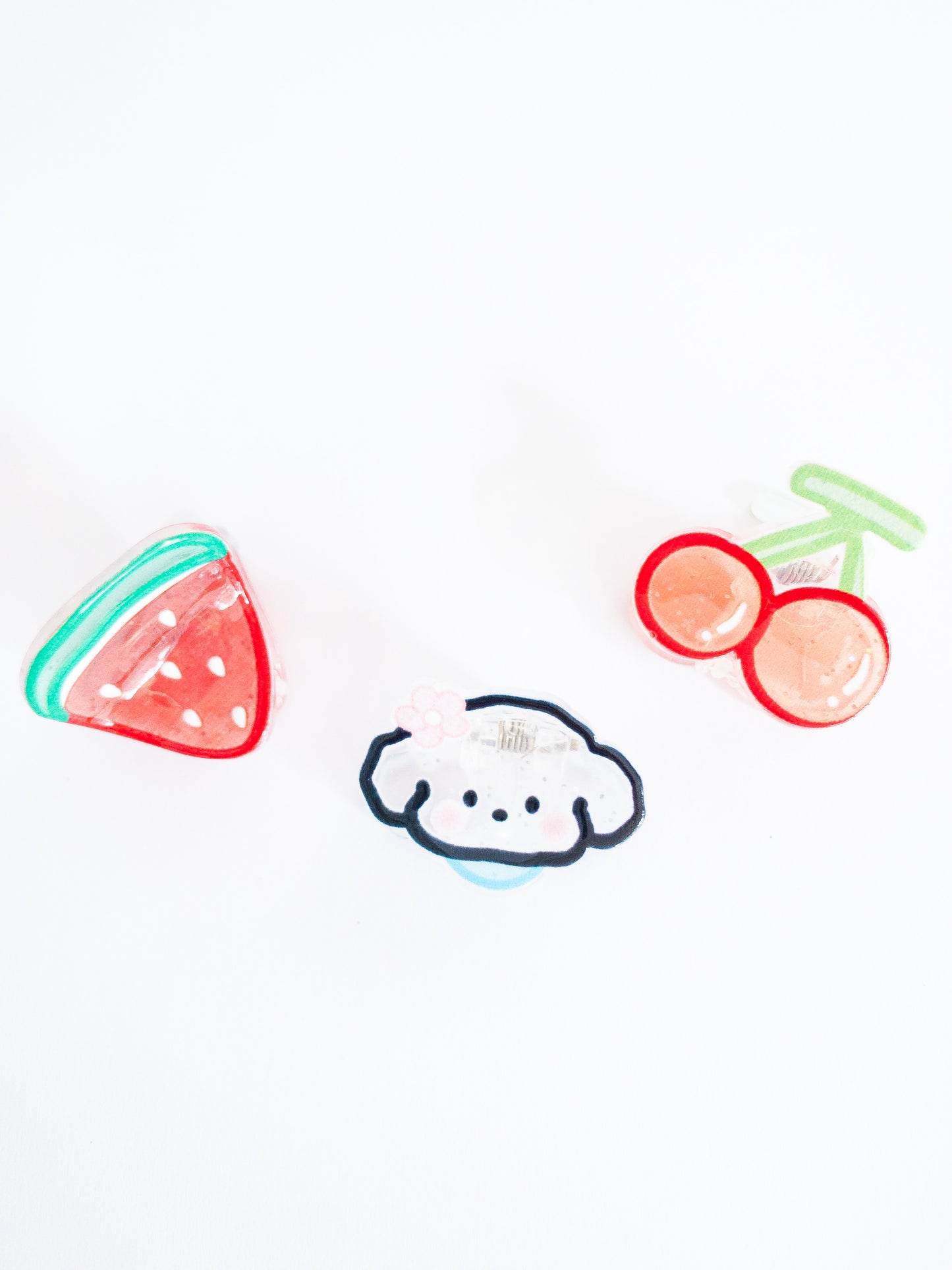 This fluffy puppy loves her watermelon and cherry! A 3-pack of translucent, glittery small hair claws in the cutest shapes.