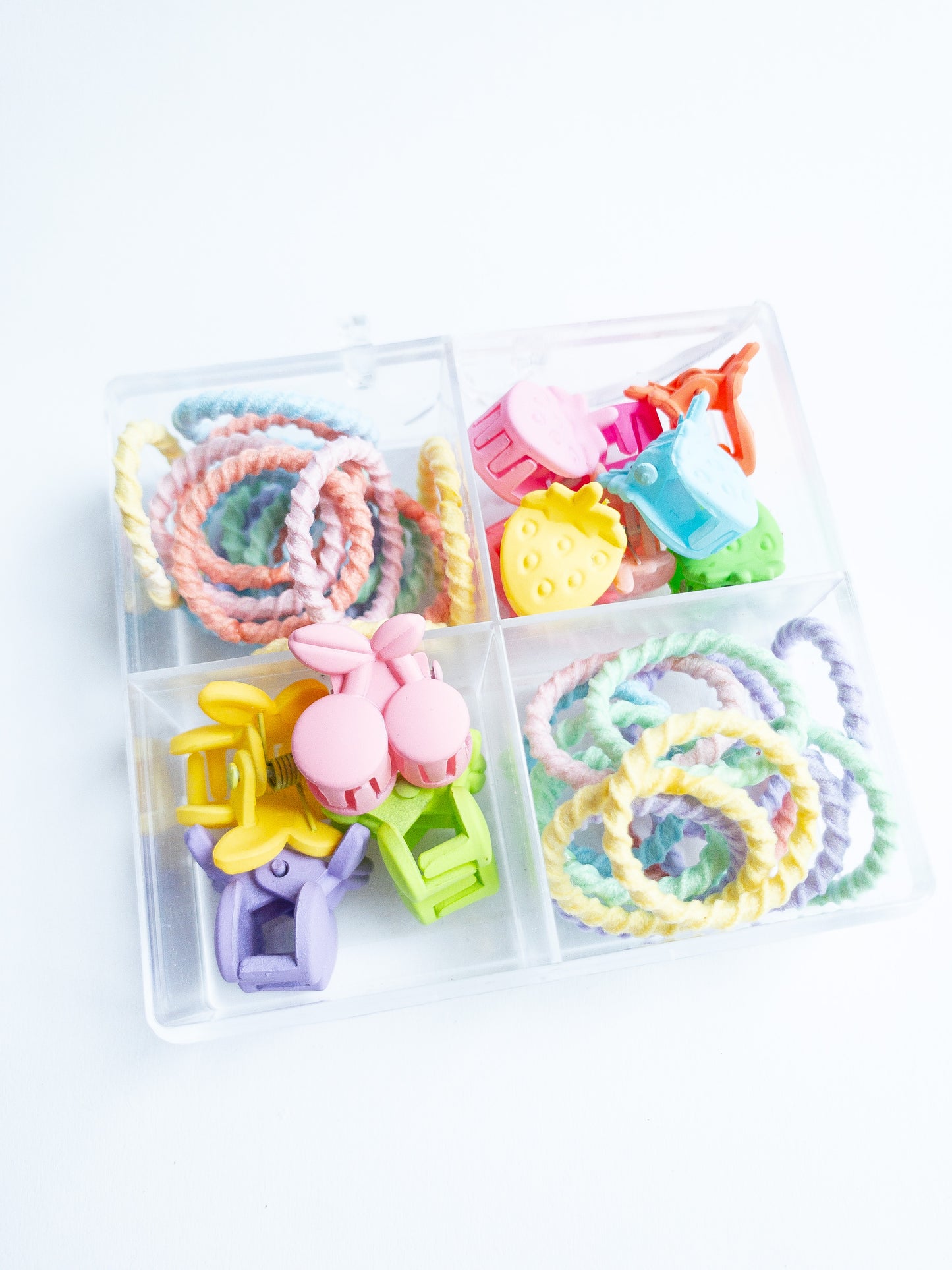 This mini hair claw set is the one you need! A boxed set with a mix of mini strawberry hair claws and a mix of small cherry hair claws along with small hair ties. The hair ties are super soft, no tug and thin, perfect for those cute pigtails or braids. Clip the hair claws throughout to make that fun style.