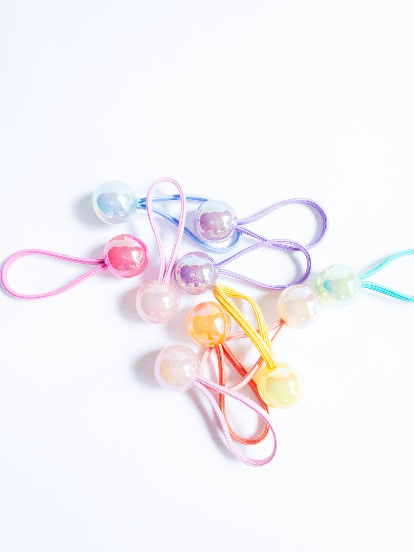 Dreamy, iridescent bubble ball hair ties! These pearly hair ties glisten and gleam in candy taffy colors. They're strong enough to hold hairstyles and cute enough to wear them all at once. Each set contains 10 hai
