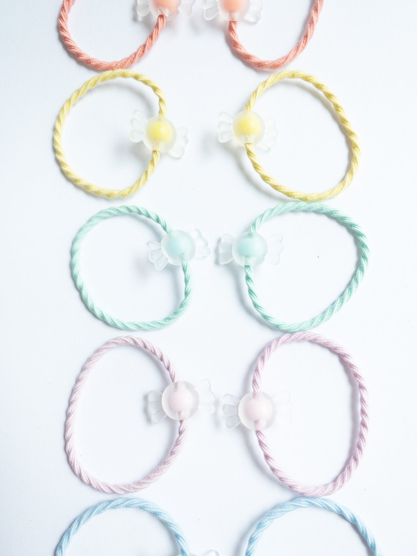 Cute little milky yogurt candies on fabric soft hair ties. Each set contains 10 hair ties.