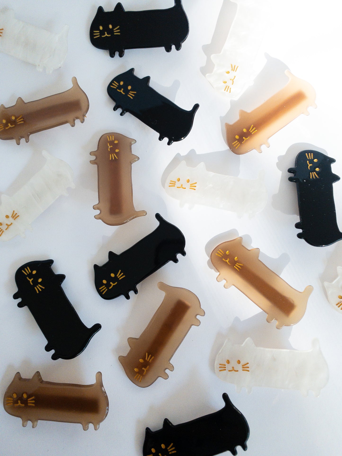 Do not fear, the meow crew is here! Long, slinky, happy cat hair clips in light brown, midnight black and shimmery, swirly white.