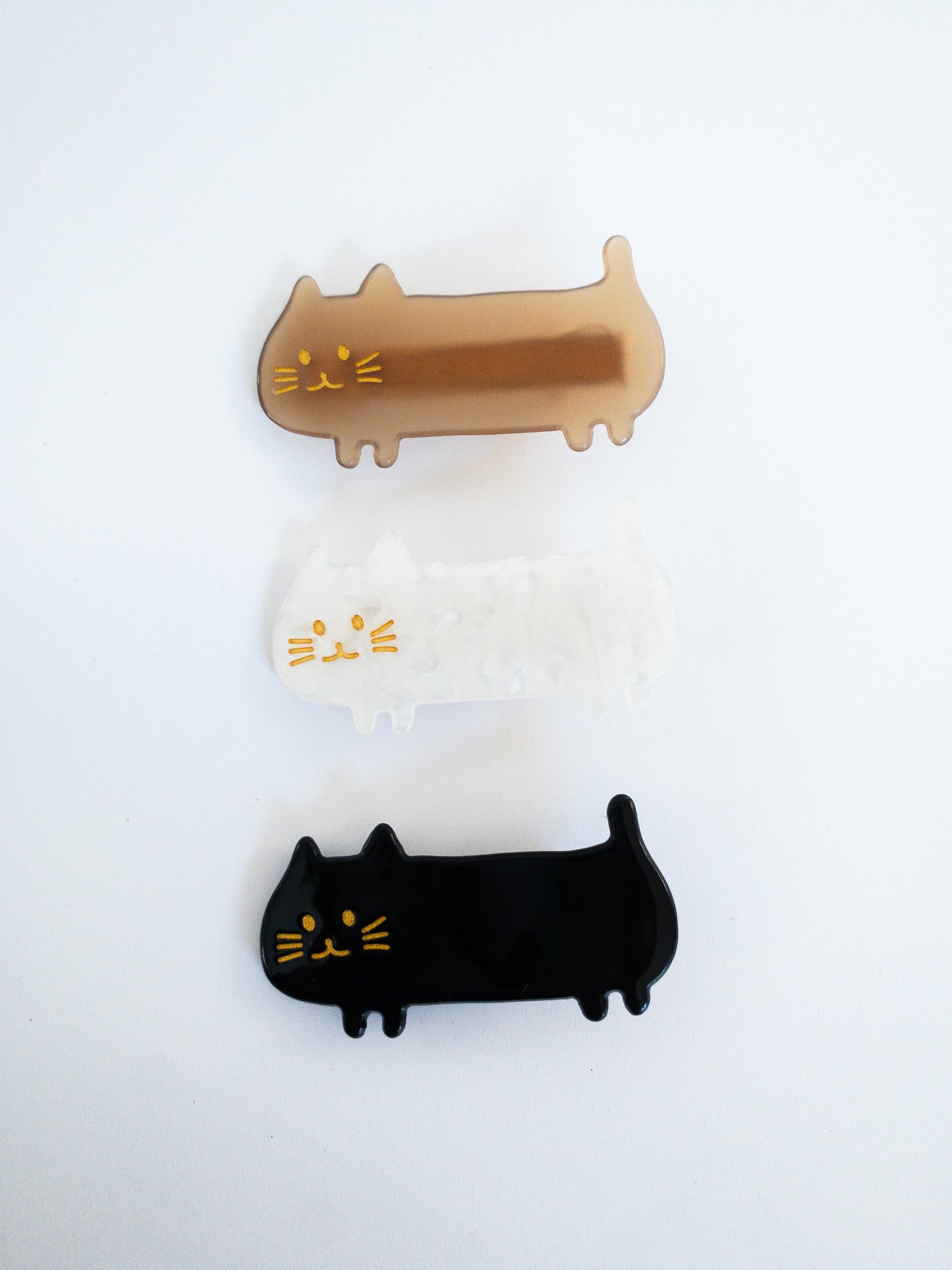 Do not fear, the meow crew is here! Long, slinky, happy cat hair clips in light brown, midnight black and shimmery, swirly white.