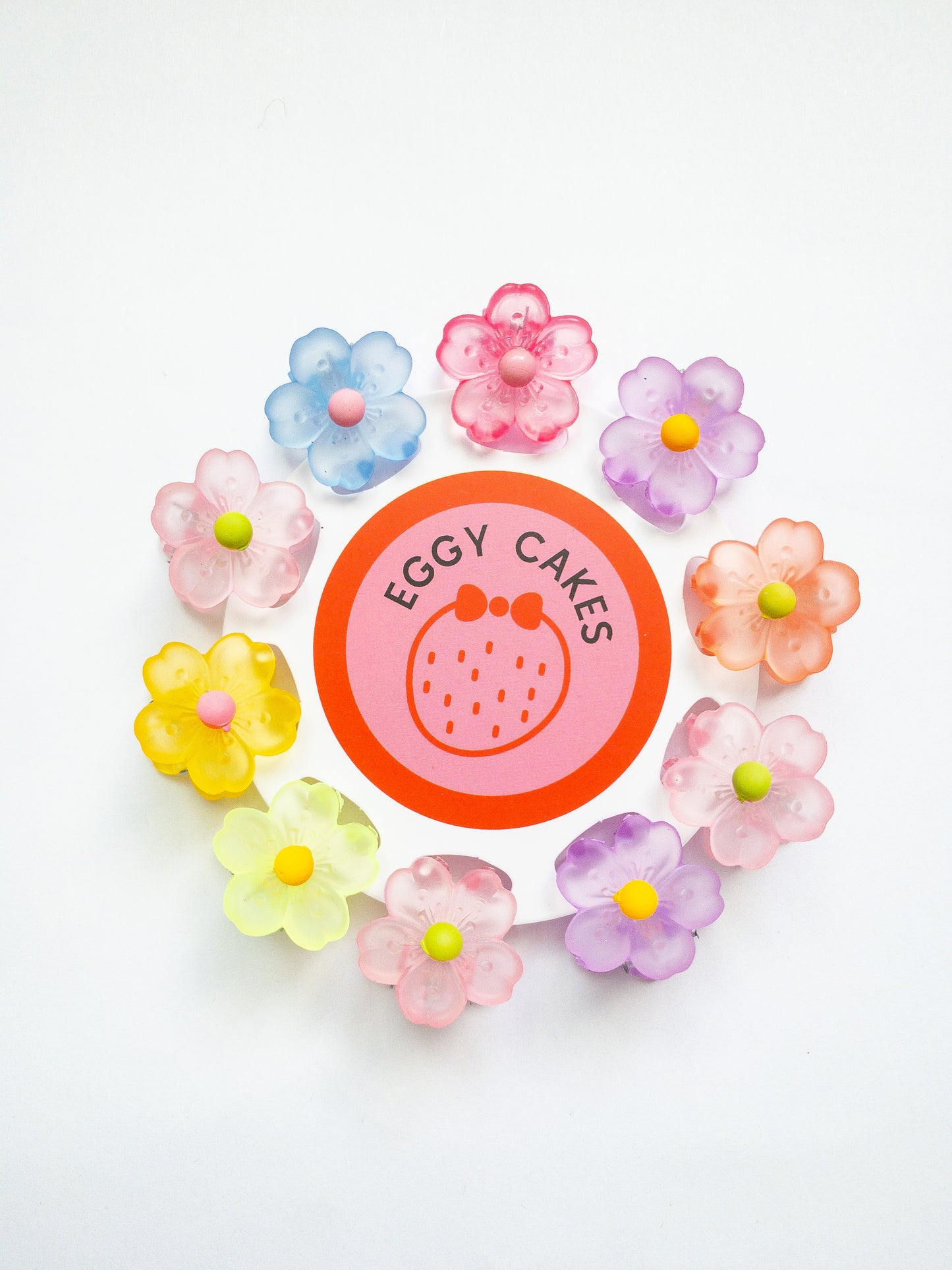 A 10-pack assortment of gorgeous little sakura cherry blossom flower hair claws. These are not mini sized but a little bigger at .75" in length. They're strong and stay in place and come in a variety of pretty milky jelly colors.