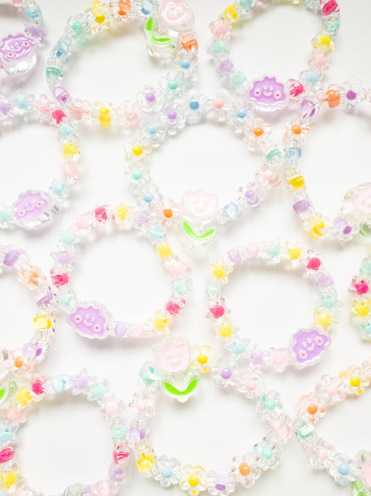 This Spring Day Bubble Bead Bracelet set is sure to bring out your inner sunshine! See-through flower and star beads on a stretchy band with a happy little tulip and cloud. A bestseller!