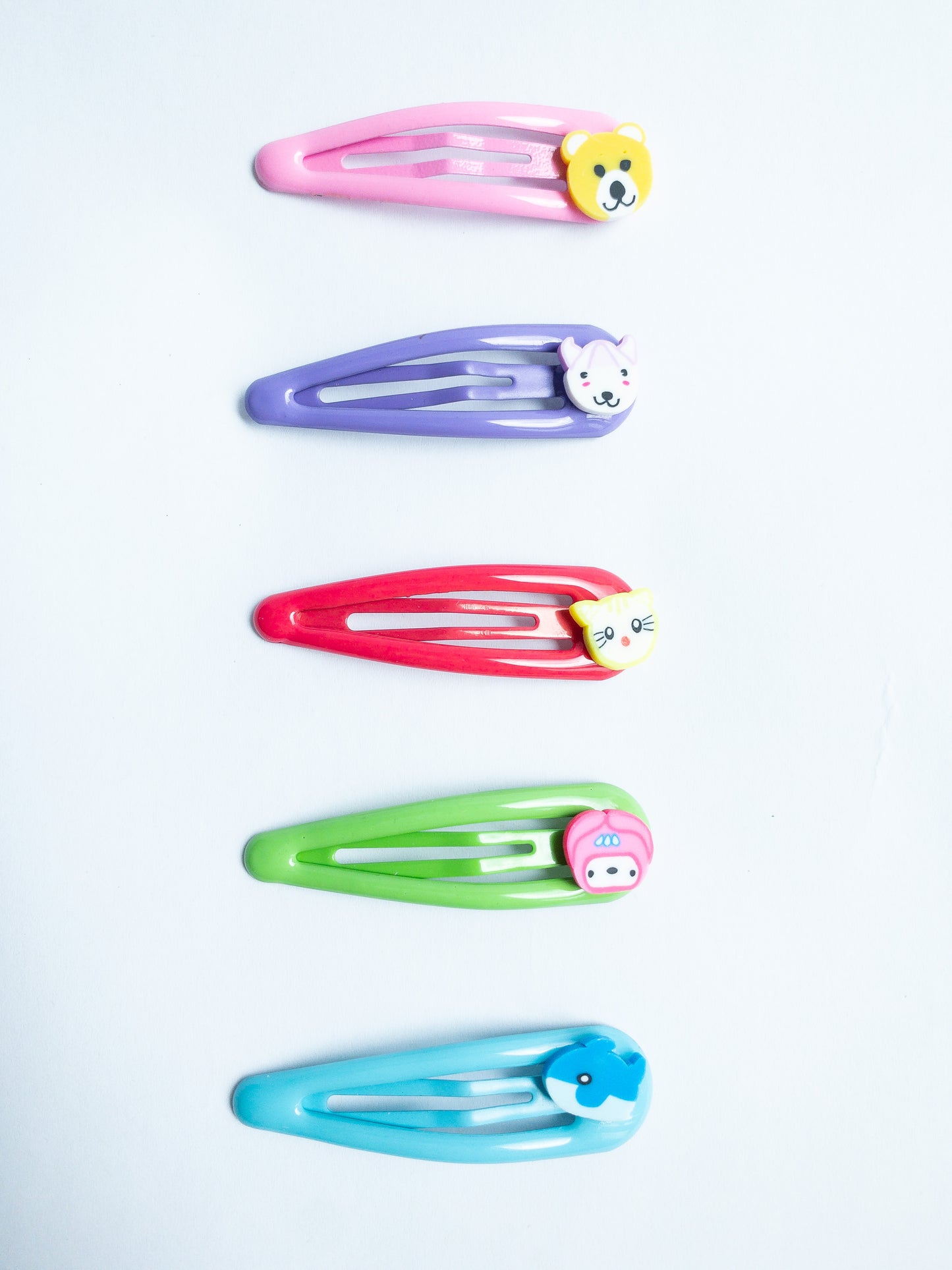 Adorn your 'do with these cute little animal hair clips! Featuring an array of critters, these super-cute clips are perfect for adding a bit of fun to your look. Five bright colored snap clips.