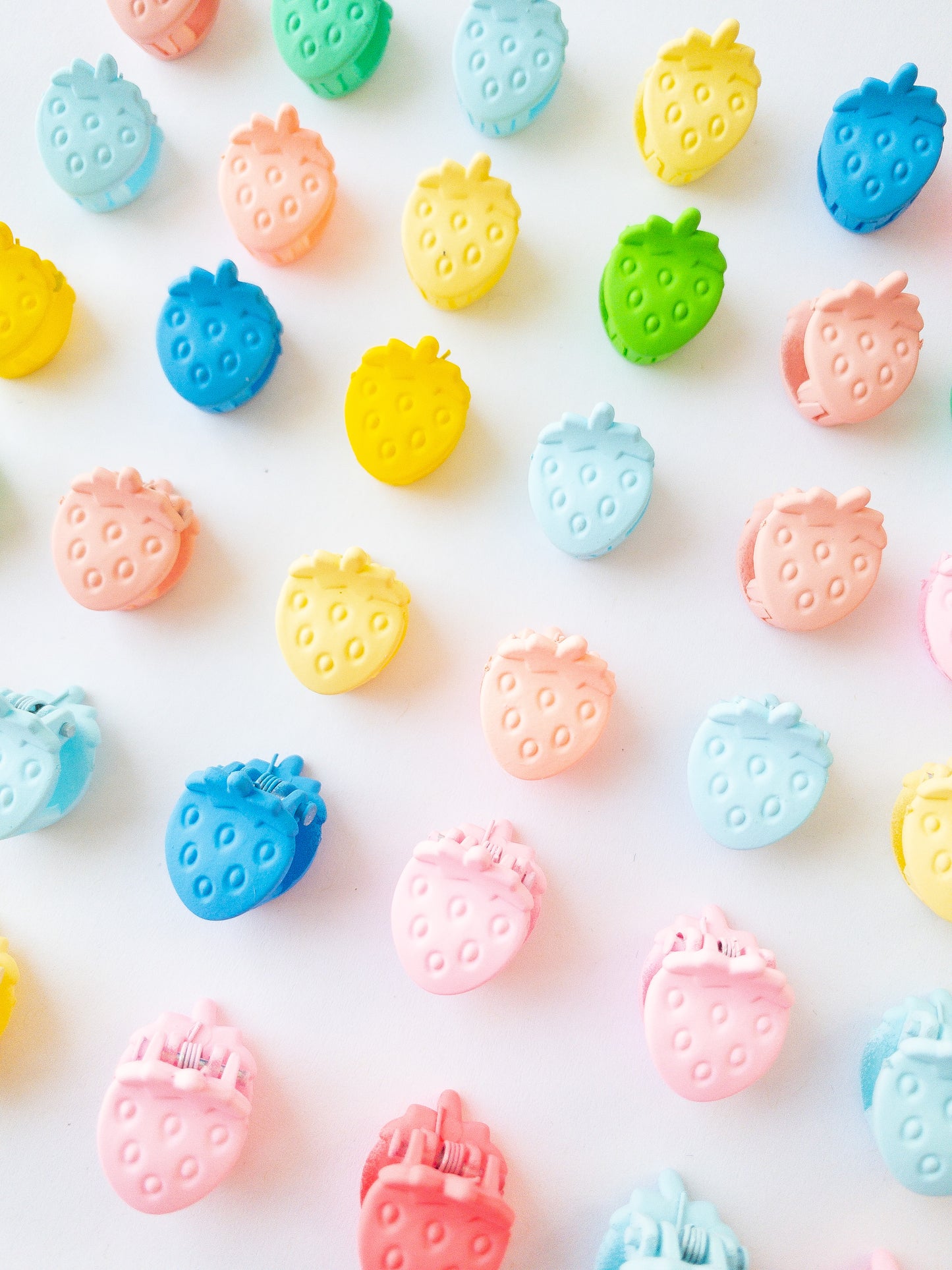 Nothing represents Eggy Cakes better than our signature mini strawberry hair clips! These adorable mini strawberries clipped through your hair look like a colorful strawberry patch and bring that extra bit of sweetness to any style. 36 sweet and dainty pieces in a variety of colors in our very own Eggy Cakes box, a perfect place to store them. Each hair clip is only half an inch in length. Have some fun with these in your own creative, fruity way. These really are a must have!