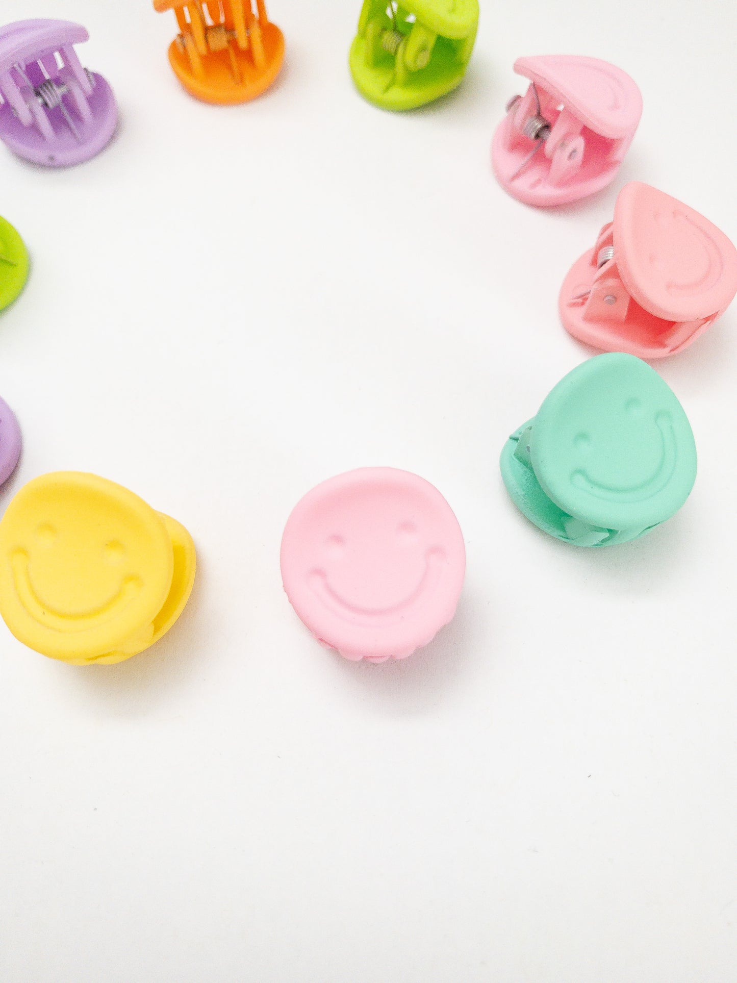 A 10-pack assortment of happy little smiley face hair claws. These are not mini sized but a little bigger at .75" in length. They're strong and stay in place and come in a variety of pretty frosted colors. Korean hair accessories, Korean accessories, Korean mini hair clips, Korean hair clips, Korean style hair accessories