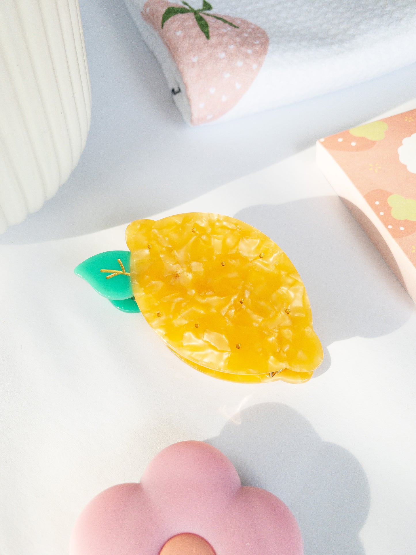 A happy yellow lemon hair claw with beautiful flecks, gold dimples, and a green leaf. Nothing brightens up your day like a sunny lemon! This hair claw clip is a medium size, great for half up hairstyles.