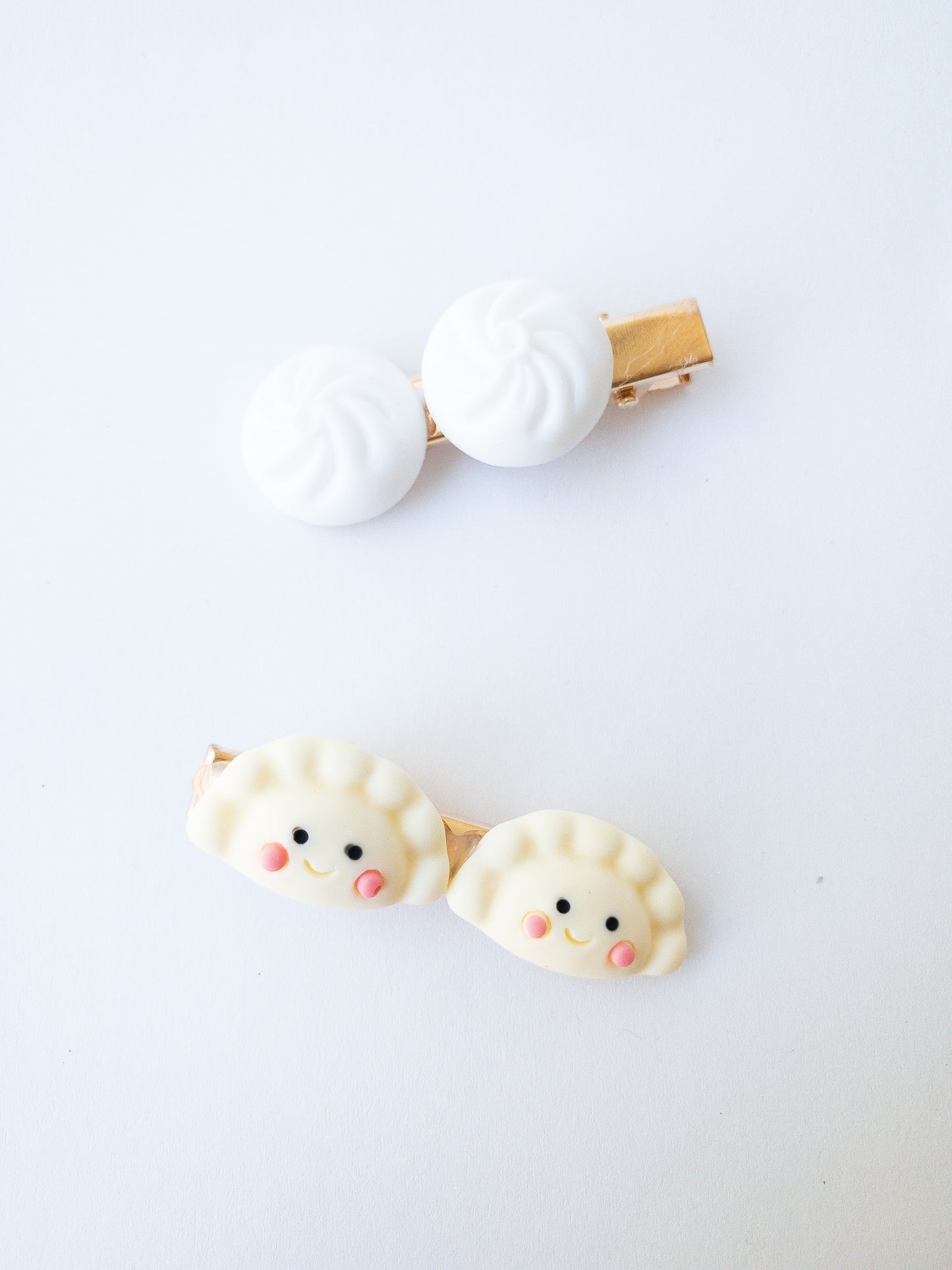 Is there anything cuter than these happy mandu dumplings and a set of bao buns? Each set comes with one mandu hair clip and one bao bun hair clip.
