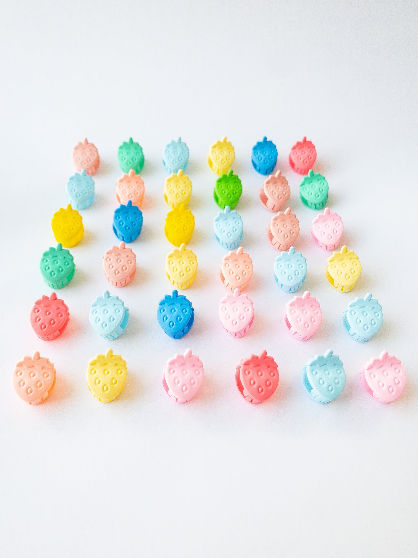 Nothing represents Eggy Cakes better than our signature mini strawberry hair clips! These adorable mini strawberries clipped through your hair look like a colorful strawberry patch and bring that extra bit of sweetness to any style. 36 sweet and dainty pieces in a variety of colors in our very own Eggy Cakes box, a perfect place to store them. Each hair clip is only half an inch in length. Have some fun with these in your own creative, fruity way. These really are a must have!