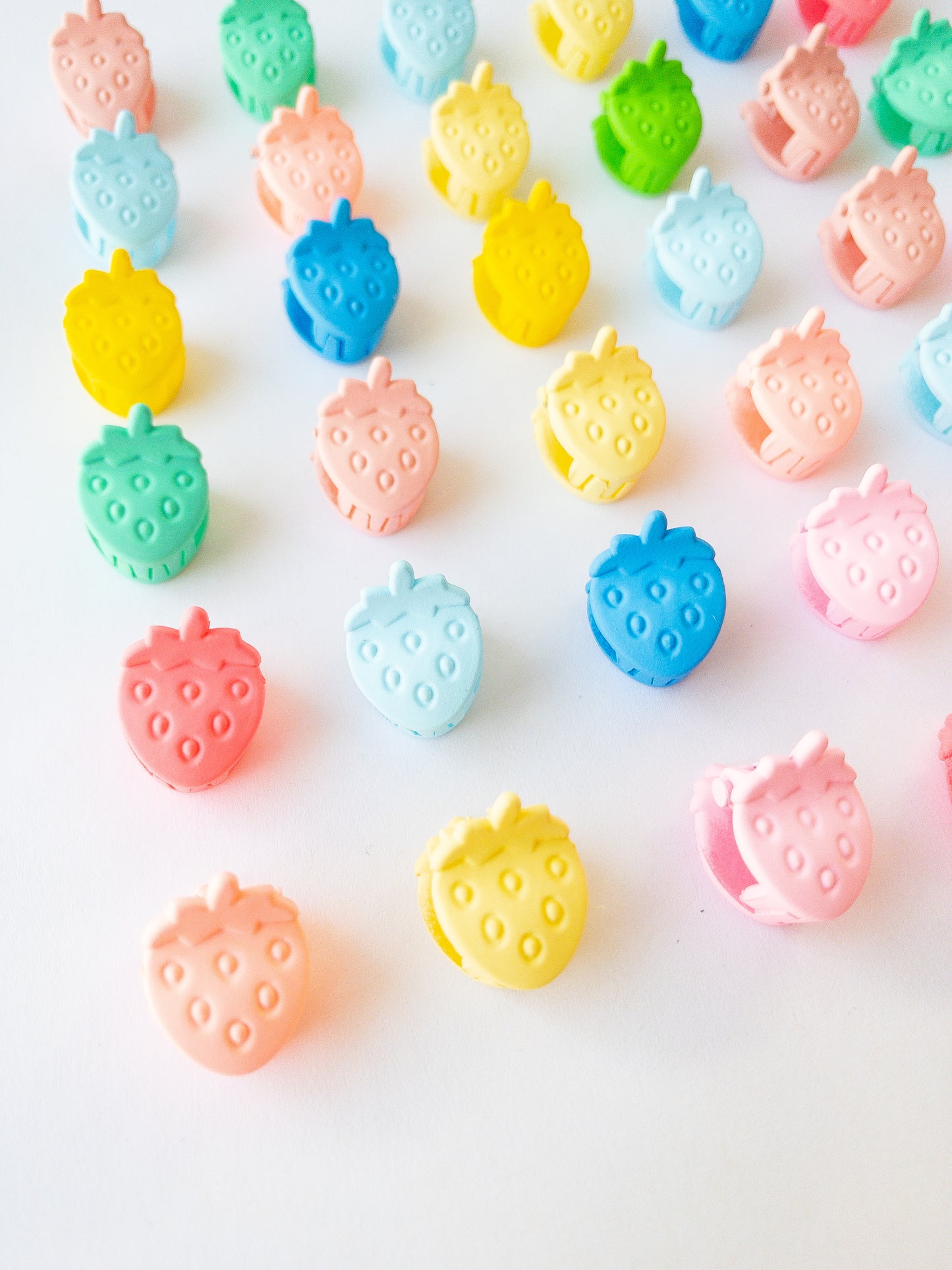 Nothing represents Eggy Cakes better than our signature mini strawberry hair clips! These adorable mini strawberries clipped through your hair look like a colorful strawberry patch and bring that extra bit of sweetness to any style. 36 sweet and dainty pieces in a variety of colors in our very own Eggy Cakes box, a perfect place to store them. Each hair clip is only half an inch in length. Have some fun with these in your own creative, fruity way. These really are a must have!