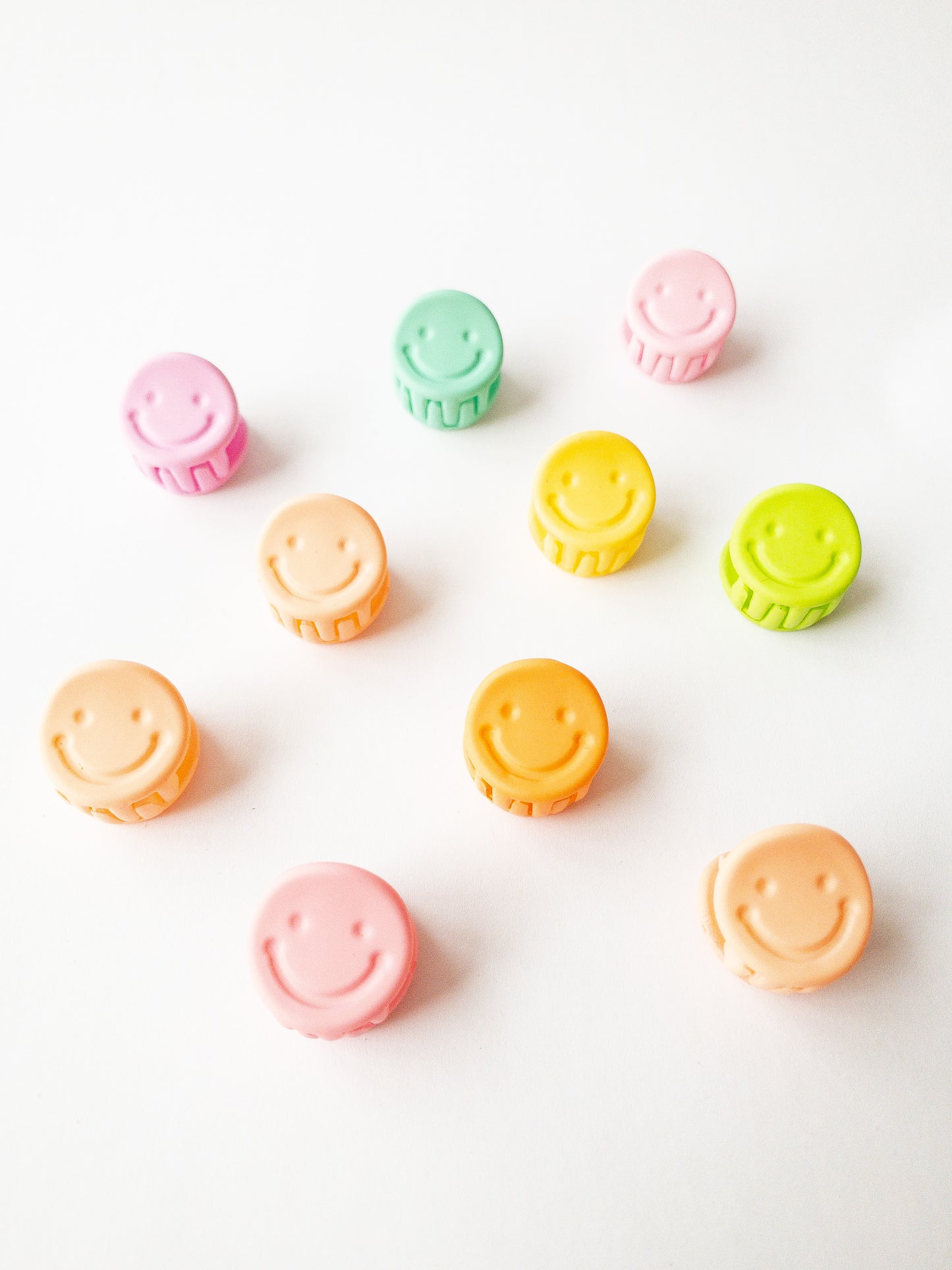 A 10-pack assortment of happy little smiley face hair claws. These are not mini sized but a little bigger at .75" in length. They're strong and stay in place and come in a variety of pretty frosted colors.