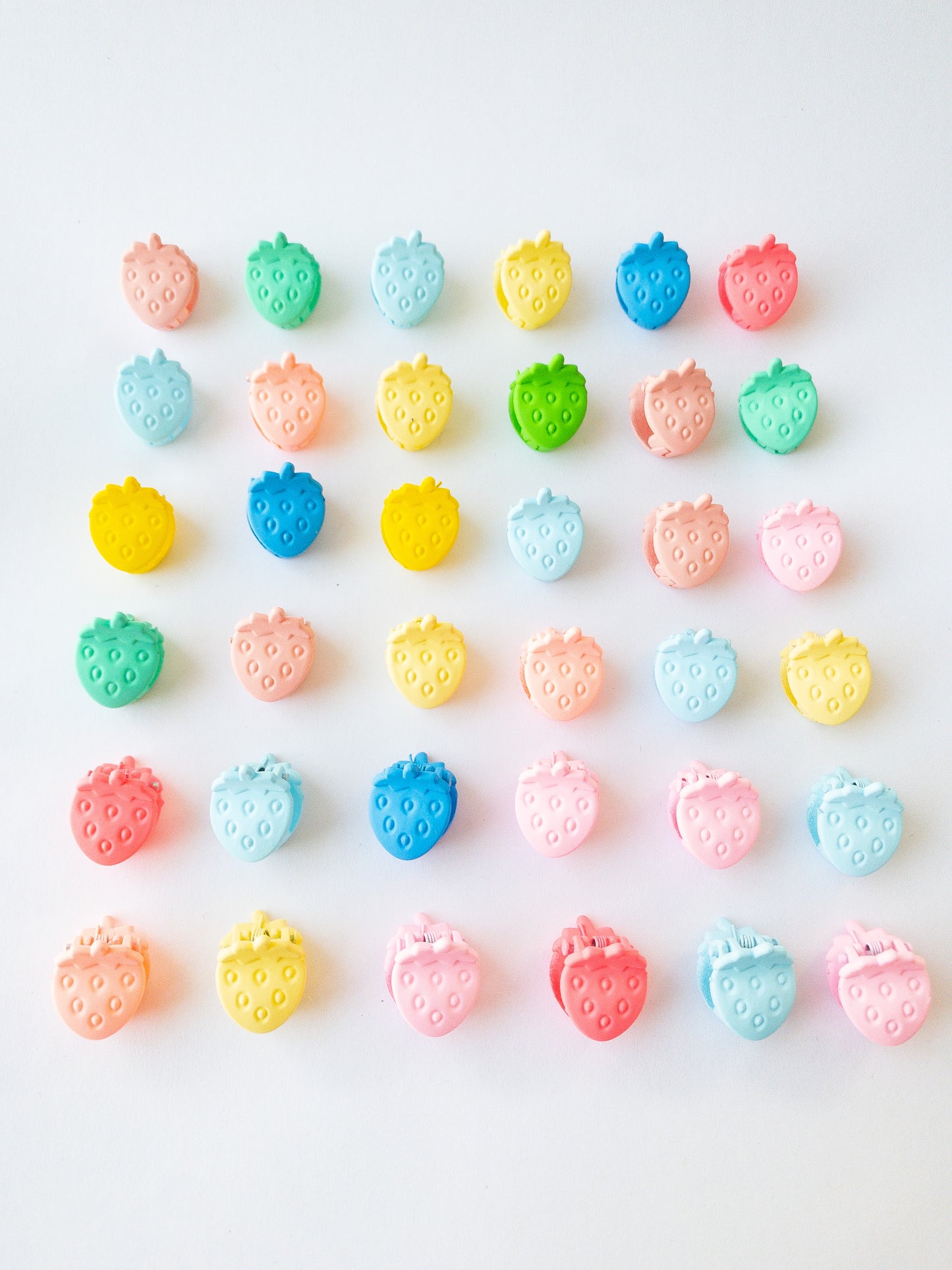 Nothing represents Eggy Cakes better than our signature mini strawberry hair clips! These adorable mini strawberries clipped through your hair look like a colorful strawberry patch and bring that extra bit of sweetness to any style. 36 sweet and dainty pieces in a variety of colors in our very own Eggy Cakes box, a perfect place to store them. Each hair clip is only half an inch in length. Have some fun with these in your own creative, fruity way. These really are a must have!
