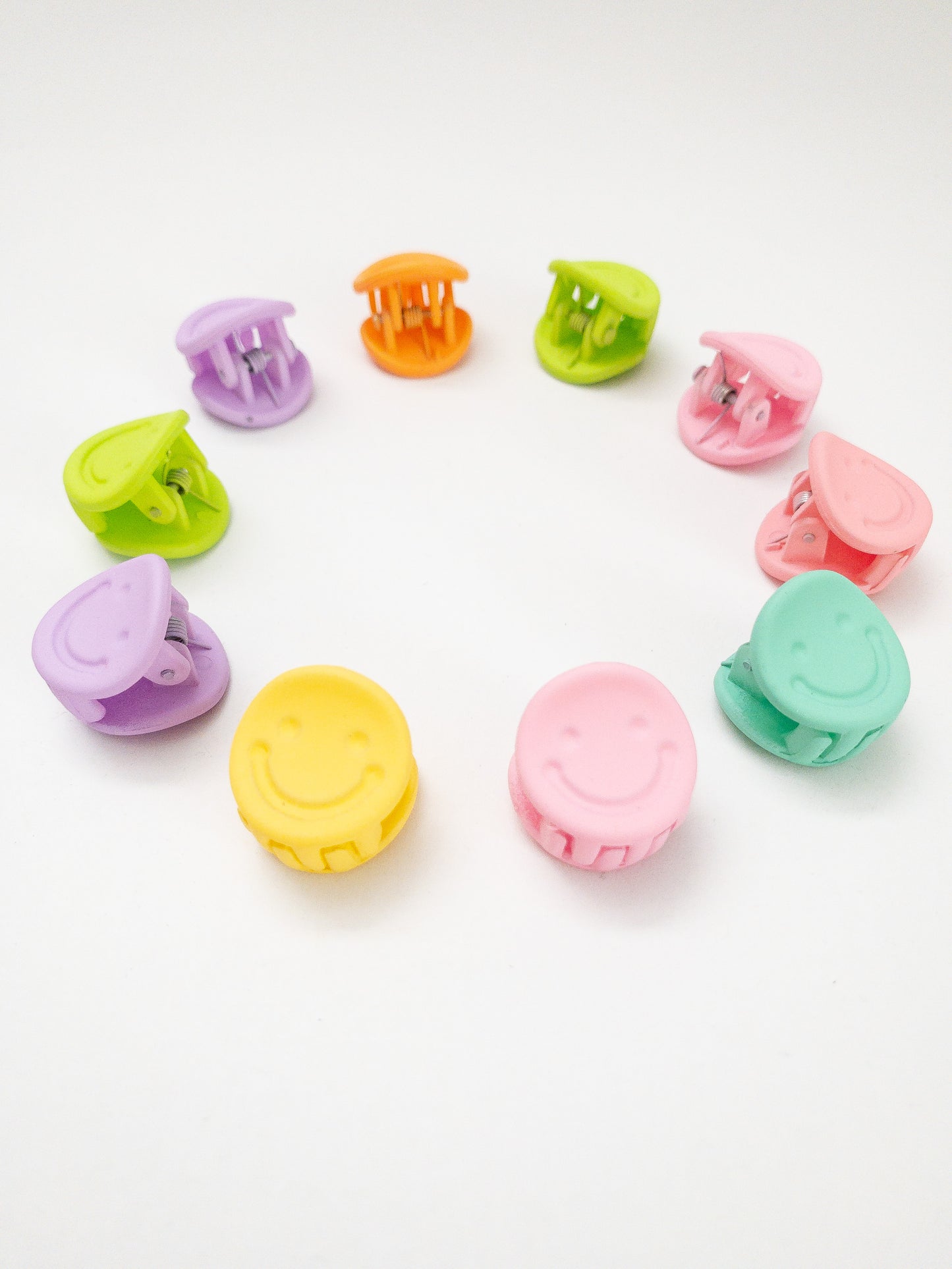 A 10-pack assortment of happy little smiley face hair claws. These are not mini sized but a little bigger at .75" in length. They're strong and stay in place and come in a variety of pretty frosted colors. Korean hair accessories, Korean accessories, Korean mini hair clips, Korean hair clips, Korean style hair accessories
