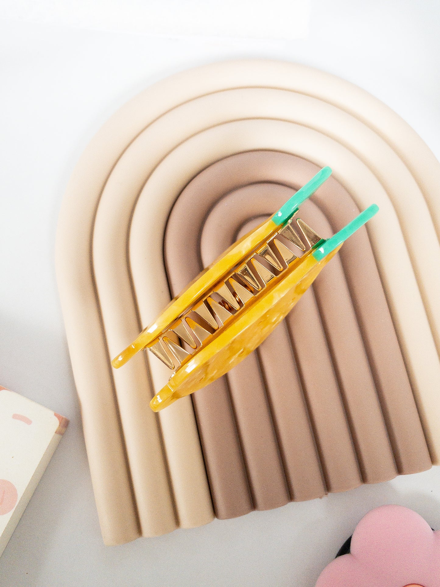 A happy yellow lemon hair claw with beautiful flecks, gold dimples, and a green leaf. Nothing brightens up your day like a sunny lemon! This hair claw clip is a medium size, great for half up hairstyles.