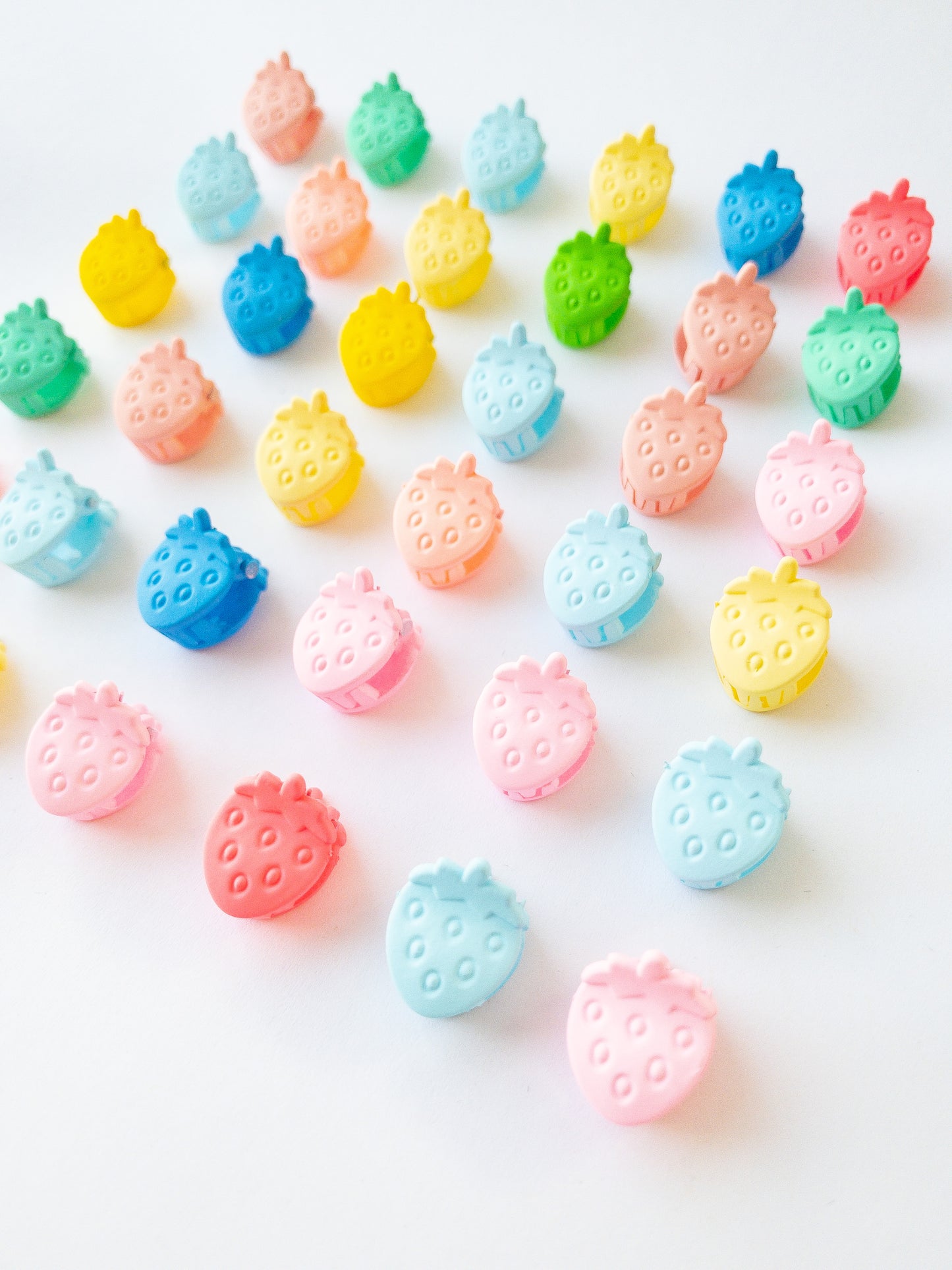 Nothing represents Eggy Cakes better than our signature mini strawberry hair clips! These adorable mini strawberries clipped through your hair look like a colorful strawberry patch and bring that extra bit of sweetness to any style. 36 sweet and dainty pieces in a variety of colors in our very own Eggy Cakes box, a perfect place to store them. Each hair clip is only half an inch in length. Have some fun with these in your own creative, fruity way. These really are a must have!