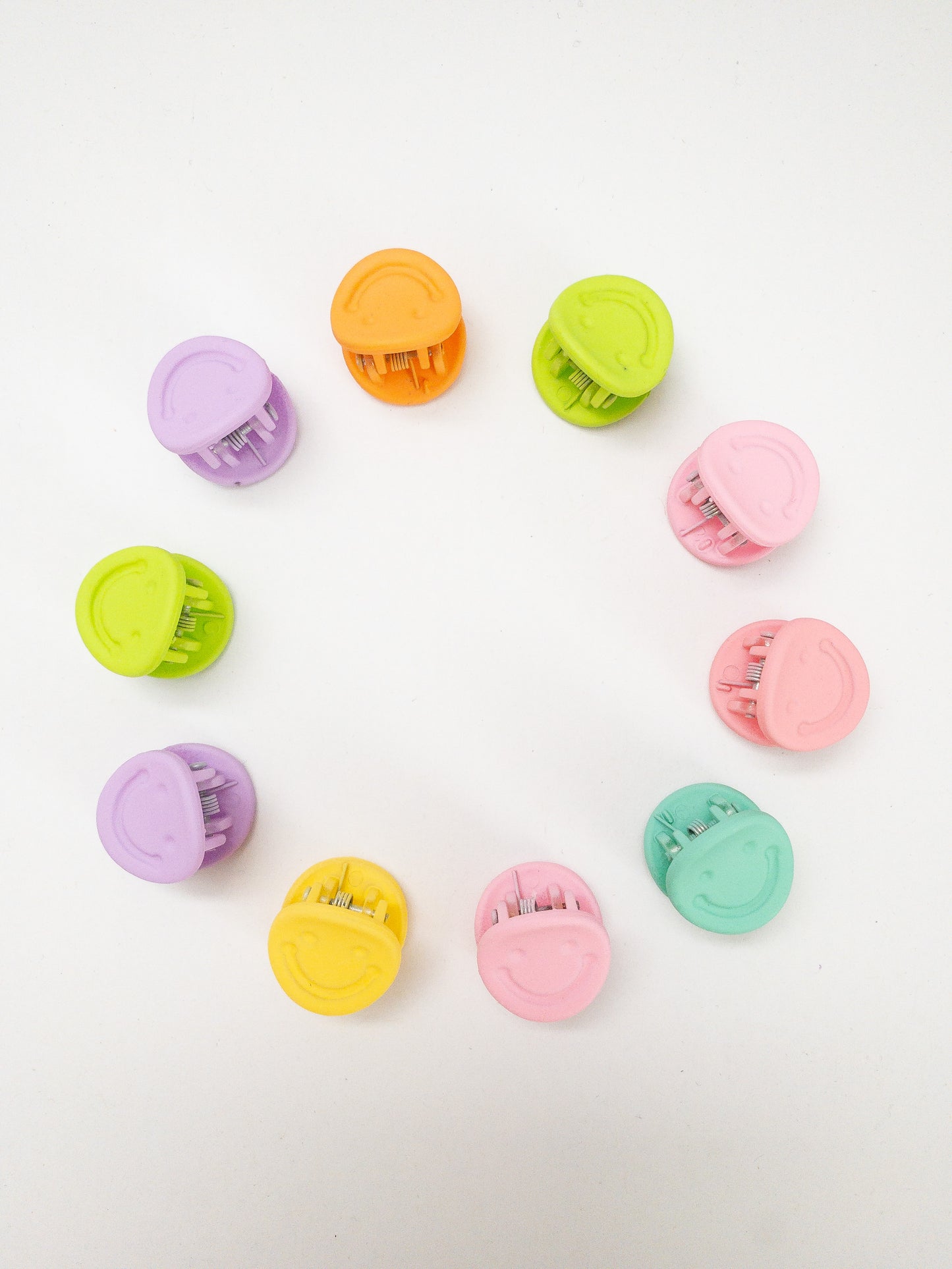 A 10-pack assortment of happy little smiley face hair claws. These are not mini sized but a little bigger at .75" in length. They're strong and stay in place and come in a variety of pretty frosted colors. Korean hair accessories, Korean accessories, Korean mini hair clips, Korean hair clips, Korean style hair accessories