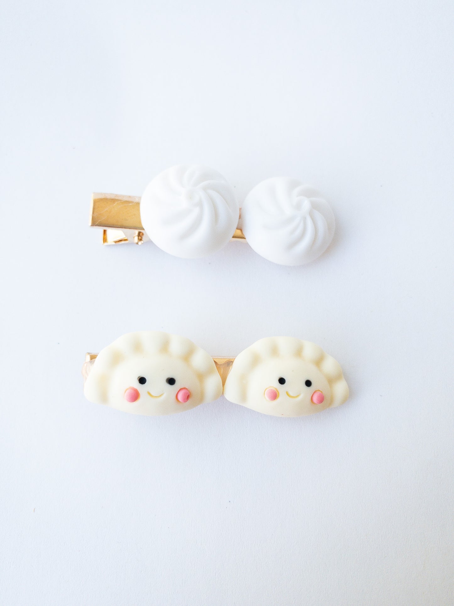 Is there anything cuter than these happy mandu dumplings and a set of bao buns? Each set comes with one mandu hair clip and one bao bun hair clip.