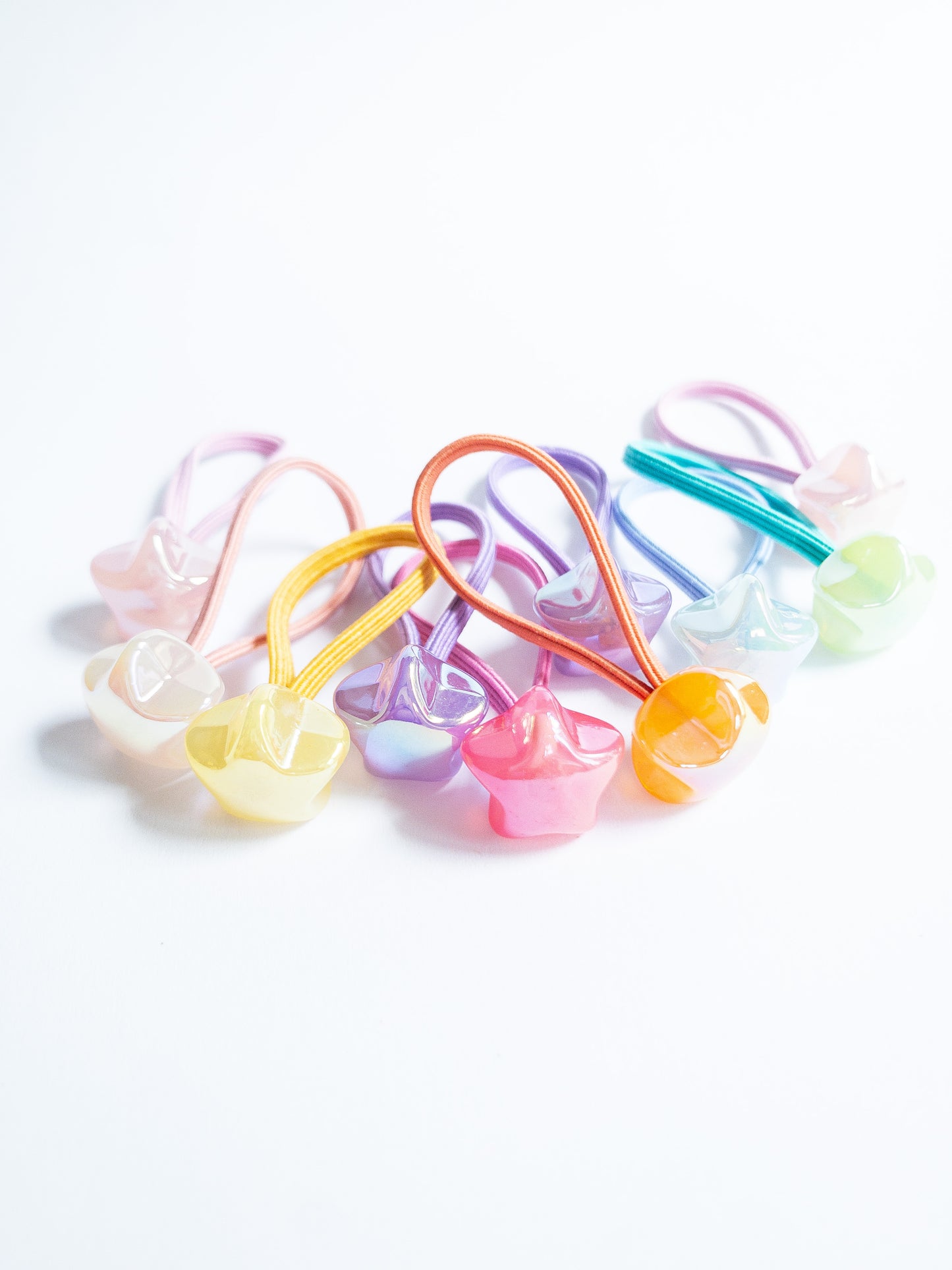 Dreamy, iridescent bubble star hair ties! These pearly hair ties glisten and gleam in candy taffy colors. They're strong enough to hold hairstyles and cute enough to wear them all at once. Each set contains 10 hair ties.