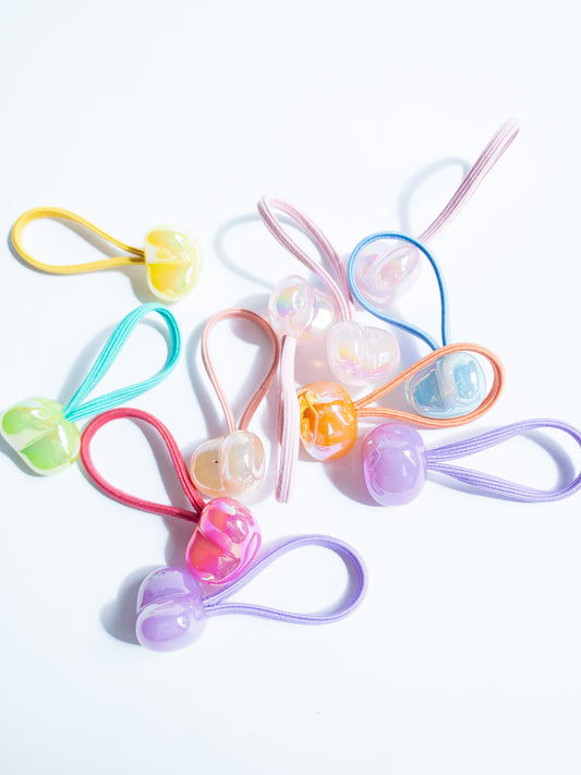 Dreamy, iridescent bubble heart hair ties! These pearly hair ties glisten and gleam in candy taffy colors. They're strong enough to hold hairstyles and cute enough to wear them all at once. Each set contains 10 hair ties.