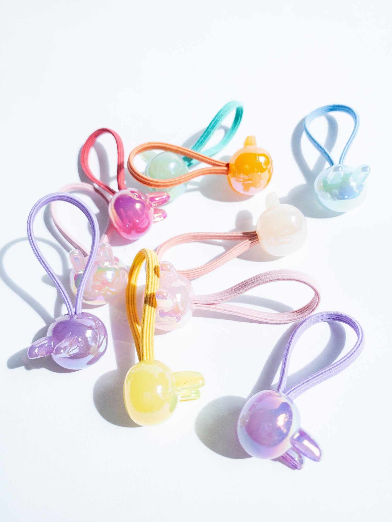 Dreamy, iridescent bubble rabbit hair ties! These pearly hair ties glisten and gleam in candy taffy colors. They're strong enough to hold hairstyles and cute enough to wear them all at once. Each set contains 10 hair ties.