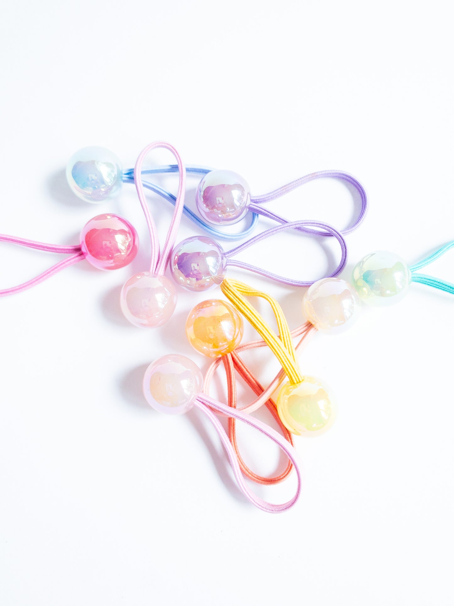 Dreamy, iridescent bubble ball hair ties! These pearly hair ties glisten and gleam in candy taffy colors. They're strong enough to hold hairstyles and cute enough to wear them all at once. Each set contains 10 hai