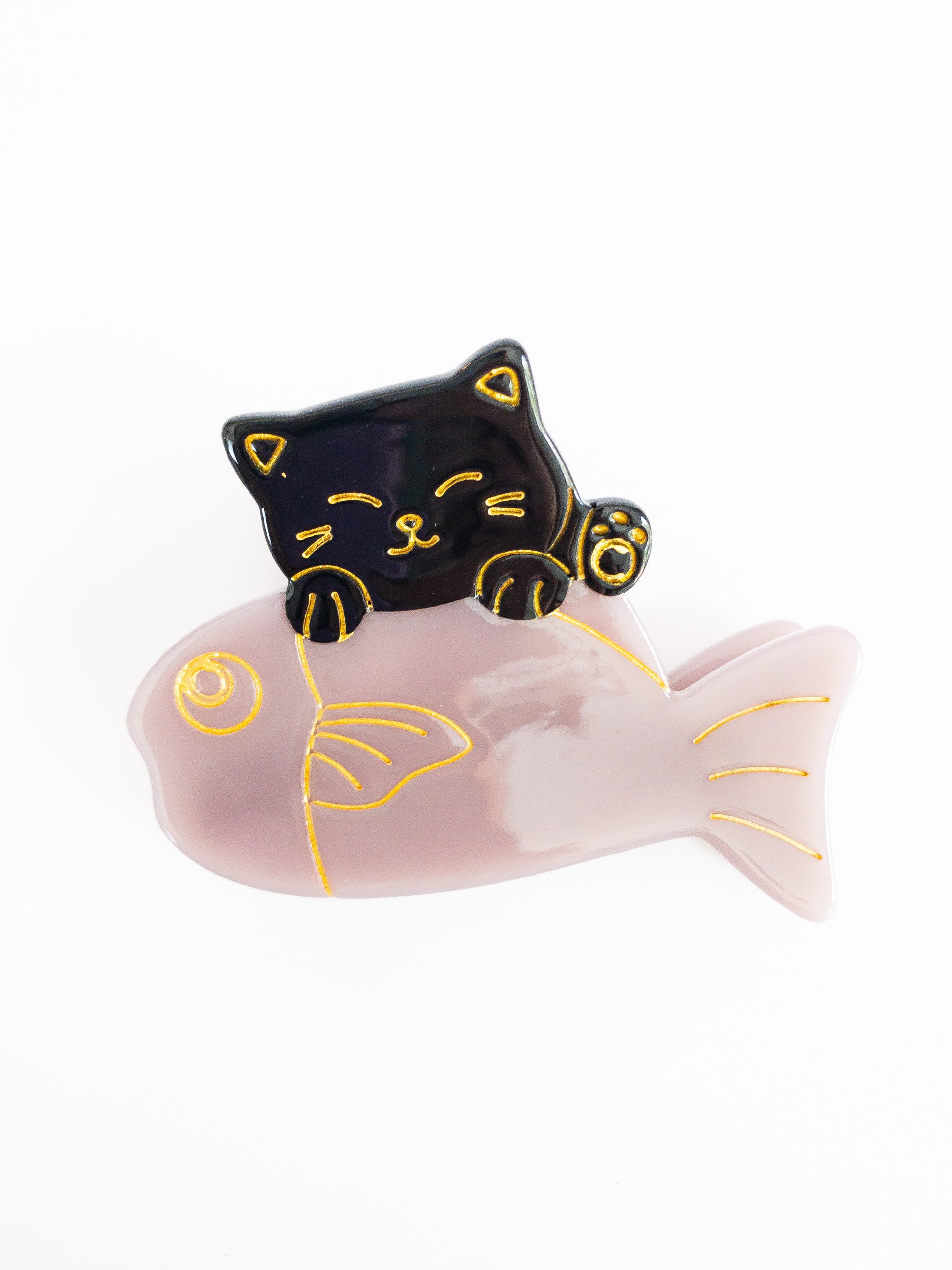 Lucky cat catches a shiny fish! This strong and sturdy cellulose acetate and pretty metal gold hair claw is the cutest way to hold your hair up. The lucky cat and the shiny light purple fish is outlined in a beautiful gold glimmer adding a gorgeous detail.