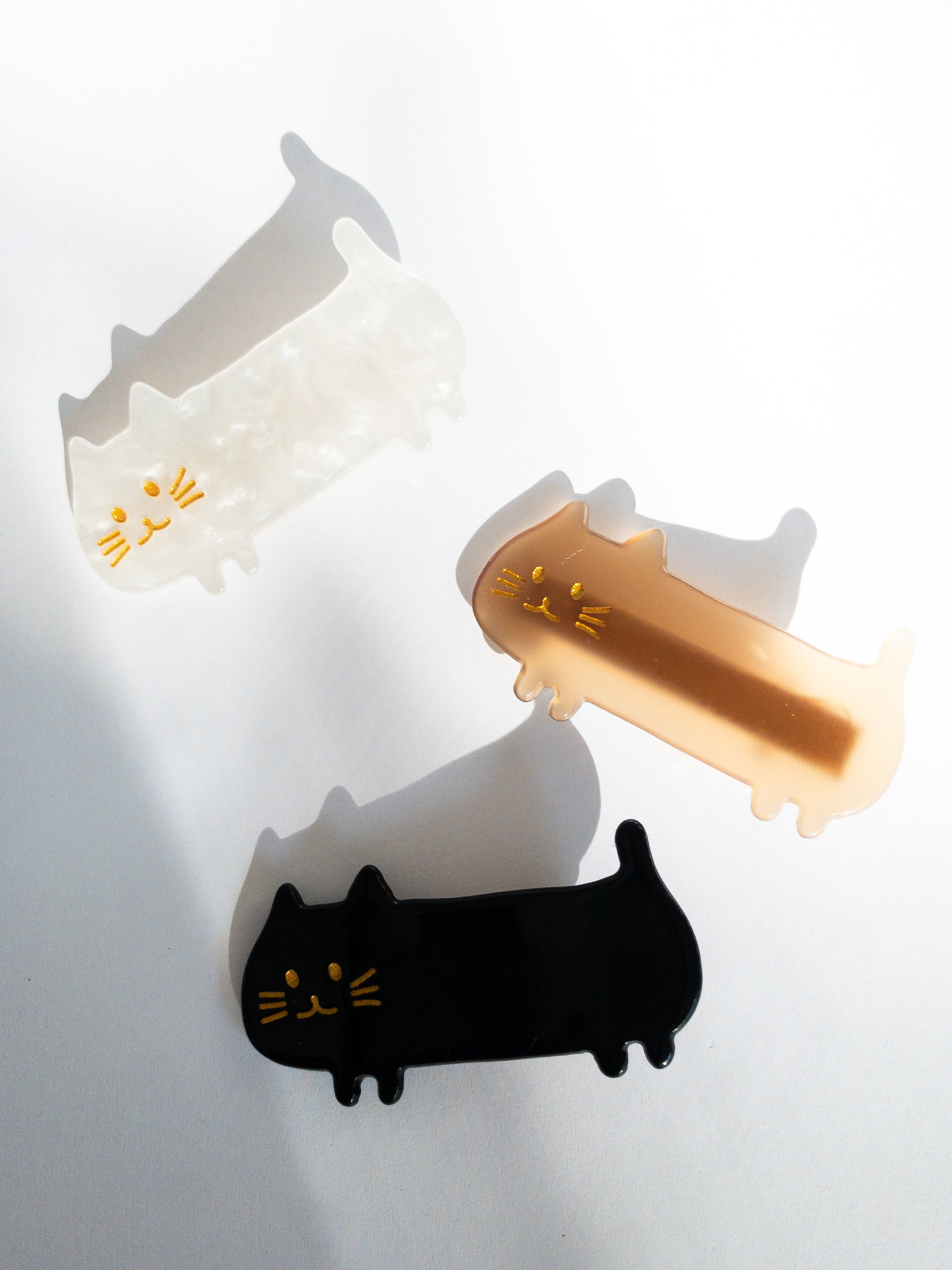 Do not fear, the meow crew is here! Long, slinky, happy cat hair clips in light brown, midnight black and shimmery, swirly white.