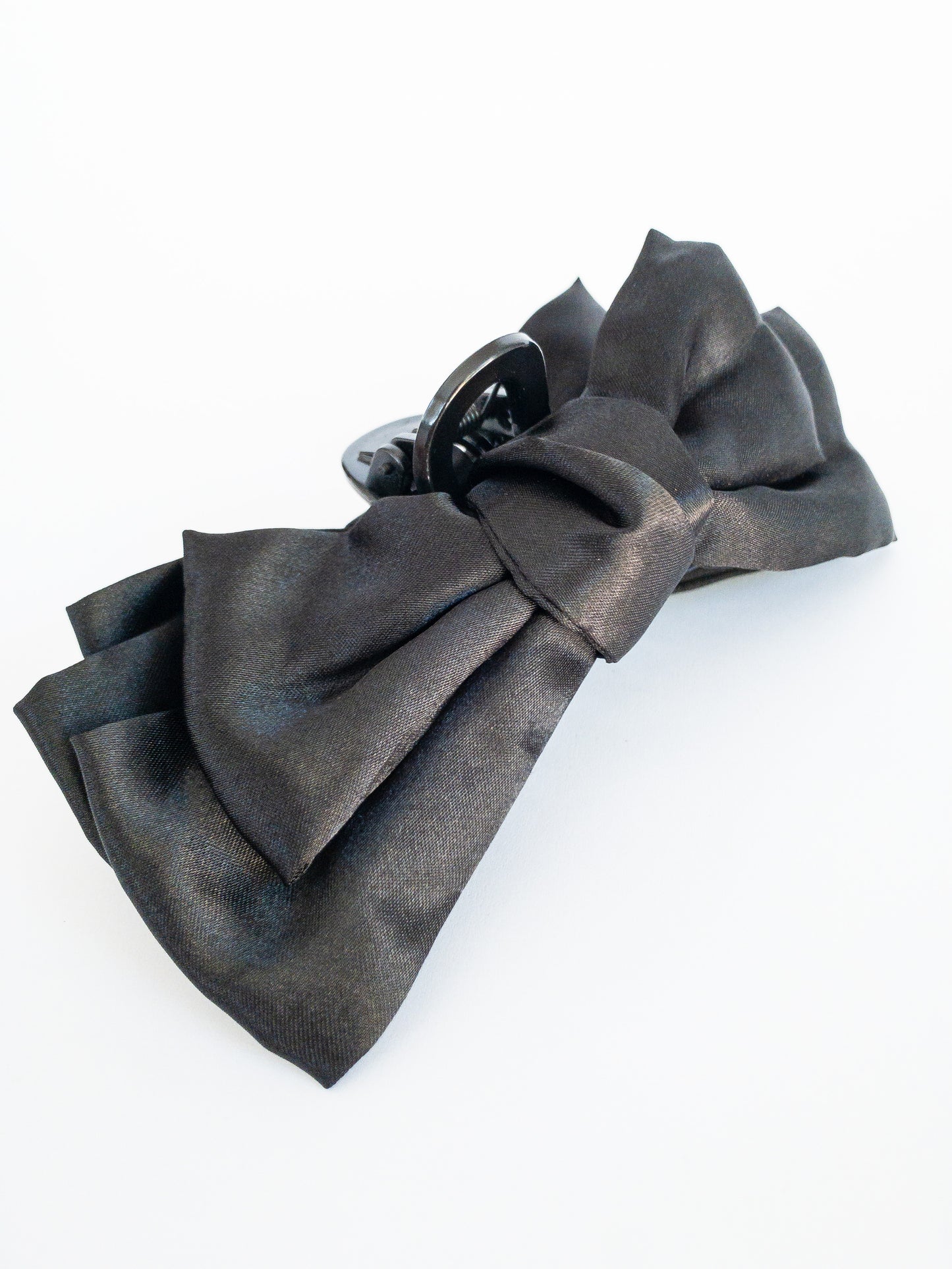 Put a bow on you, you're a gift!  This jumbo bow hair claw in a satin jet black is for those girly days. When you want to frame your face with little wispy bangs and secure it with a pretty and classic bow.