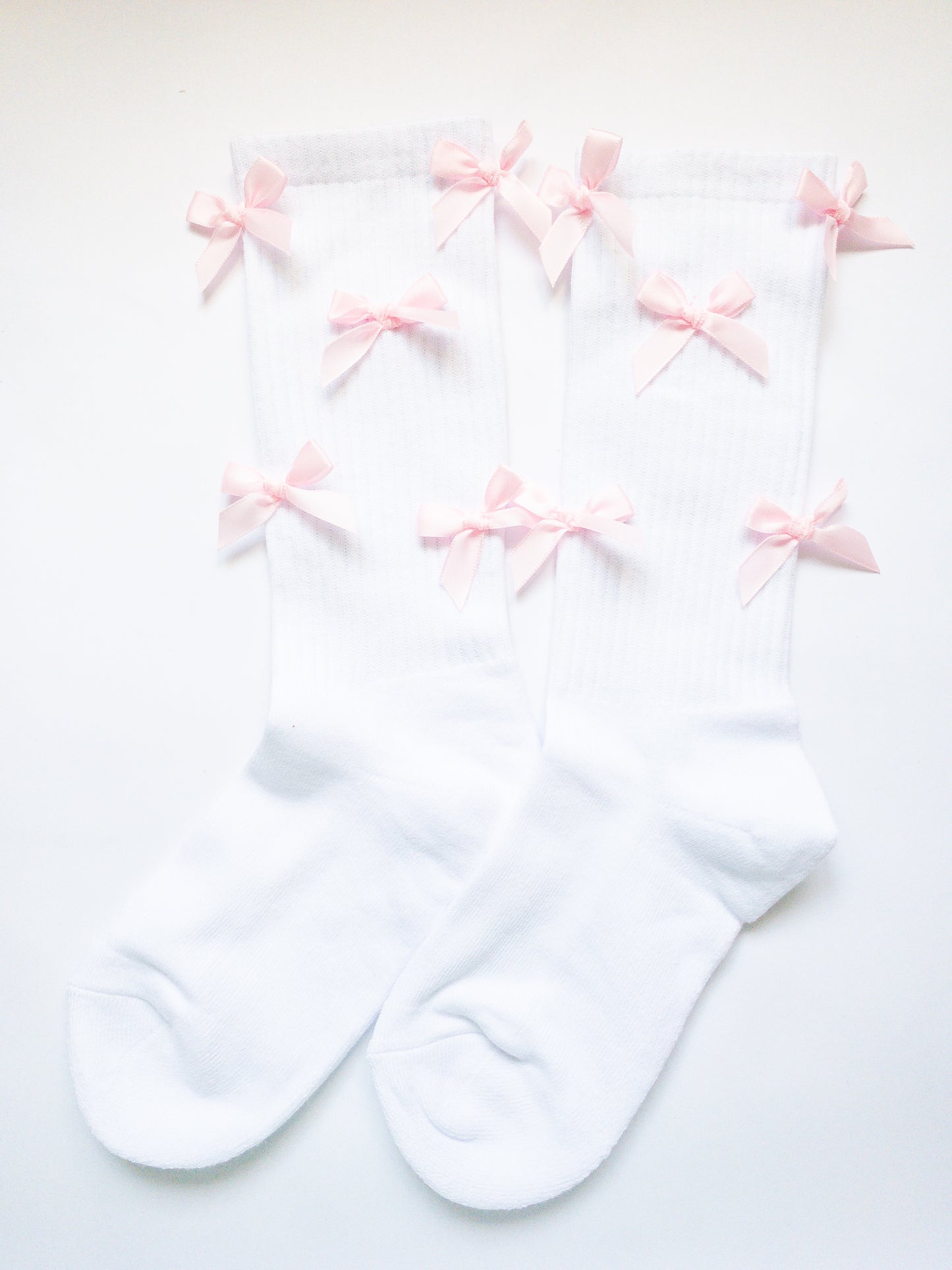 The sweetest, pink mini bow adorned knee high socks! Comfy, soft and thick, these socks are a beloved way to sweeten up your outfit. 