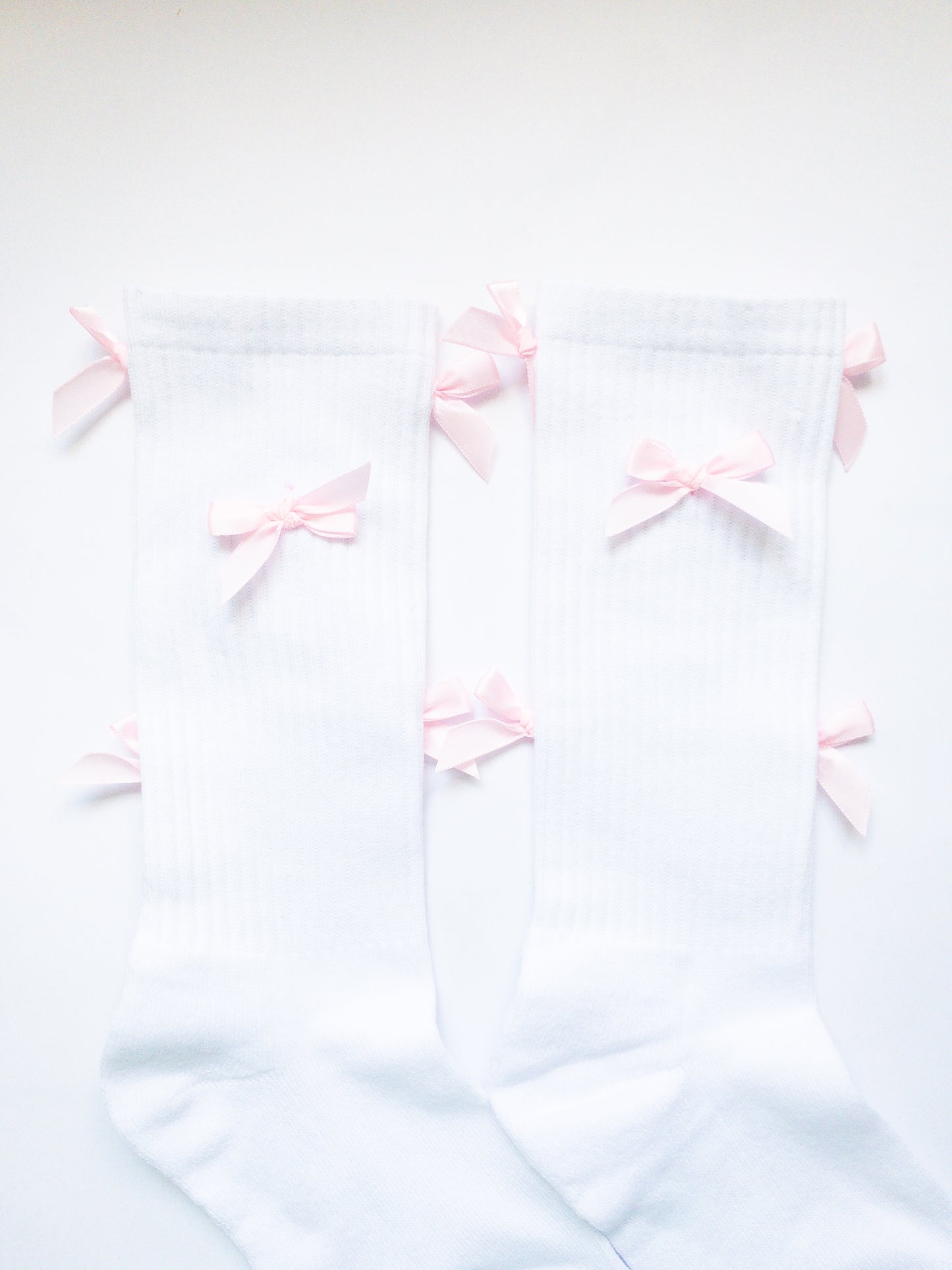 The sweetest, pink mini bow adorned knee high socks! Comfy, soft and thick, these socks are a beloved way to sweeten up your outfit. 