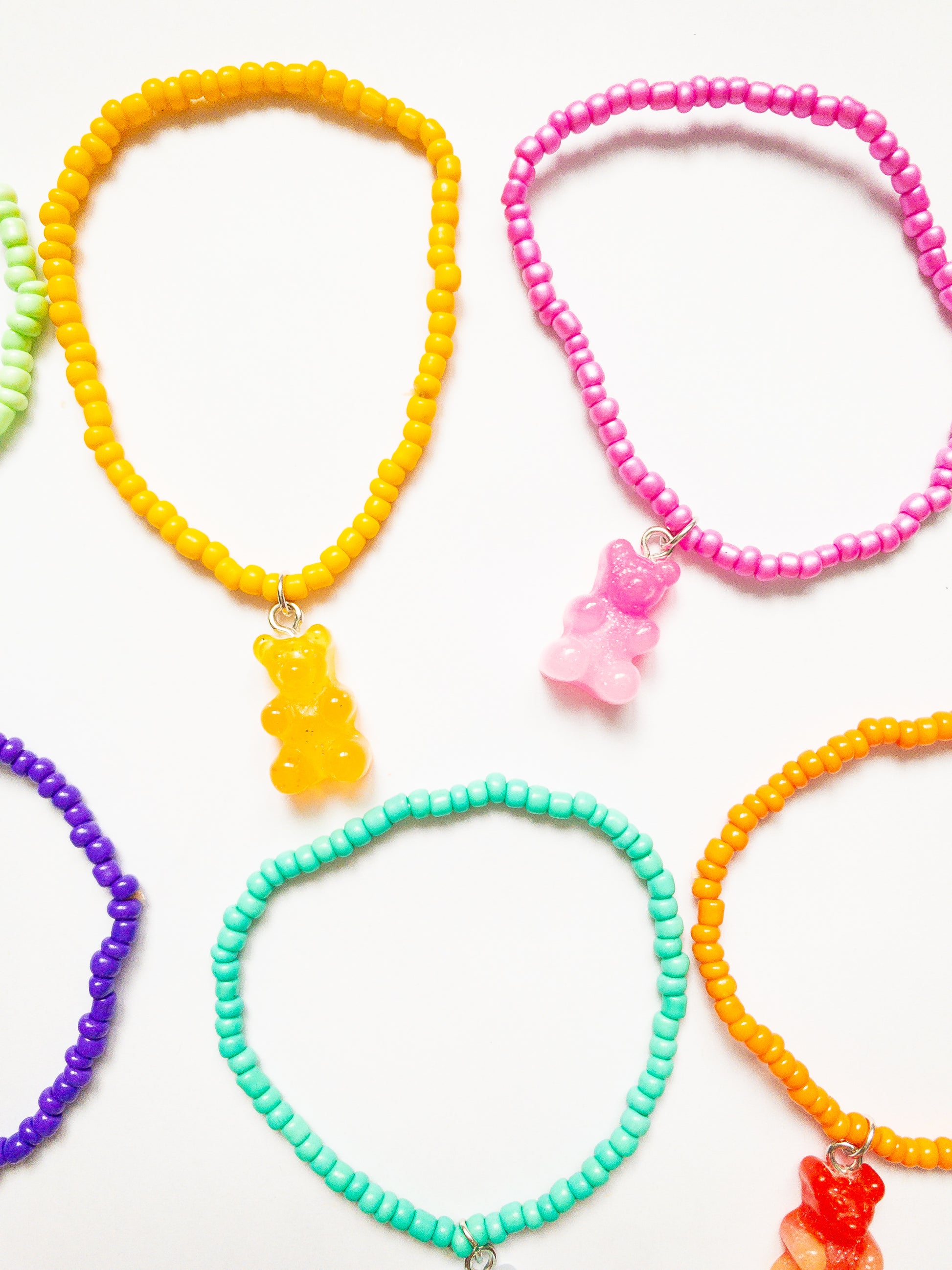 A delectable set of 6 ombre and glittery gummy bear charms on colorful stretchy beaded bracelets. 