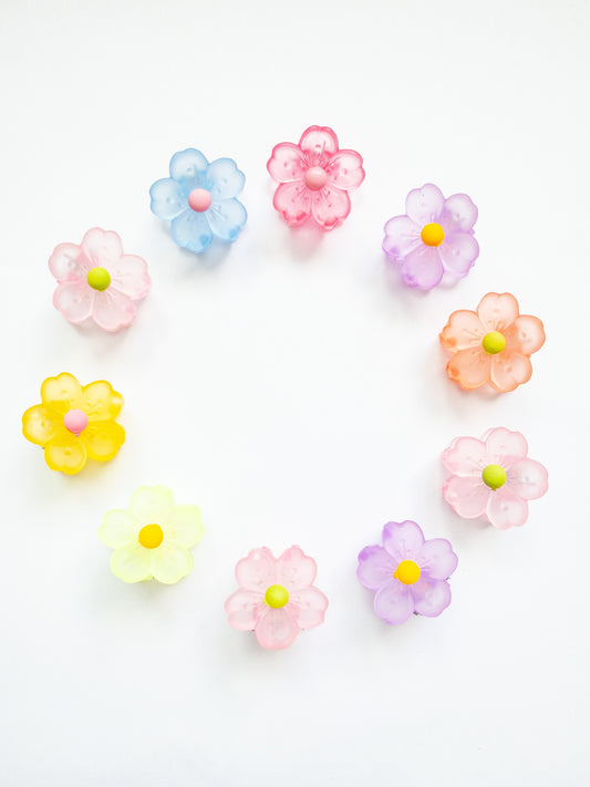 A 10-pack assortment of gorgeous little sakura cherry blossom flower hair claws. These are not mini sized but a little bigger at .75" in length. They're strong and stay in place and come in a variety of pretty milky jelly colors. 