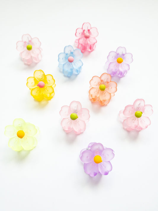 A 10-pack assortment of gorgeous little sakura cherry blossom flower hair claws. These are not mini sized but a little bigger at .75" in length. They're strong and stay in place and come in a variety of pretty milky jelly colors. 