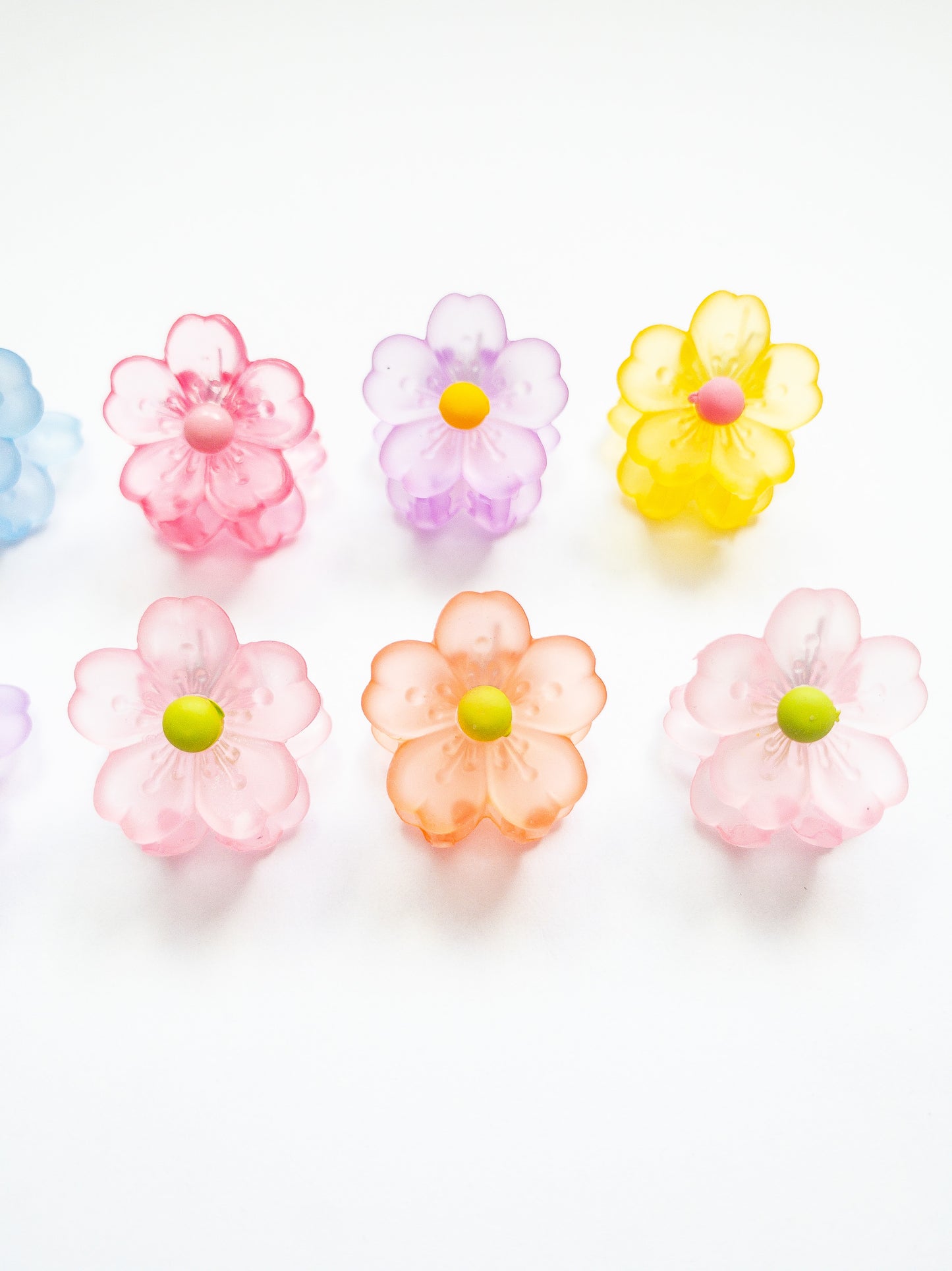 A 10-pack assortment of gorgeous little sakura cherry blossom flower hair claws. These are not mini sized but a little bigger at .75" in length. They're strong and stay in place and come in a variety of pretty milky jelly colors. 
