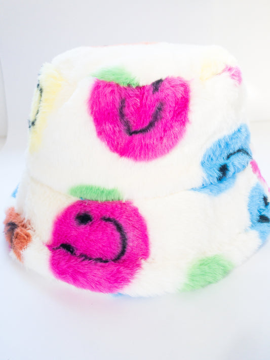 The most fun bucket hat for this season! Bright and happy smiley faces in fun colors throughout and oh so soft. Fully lined and adjustable ties on the inside for a customized fit.