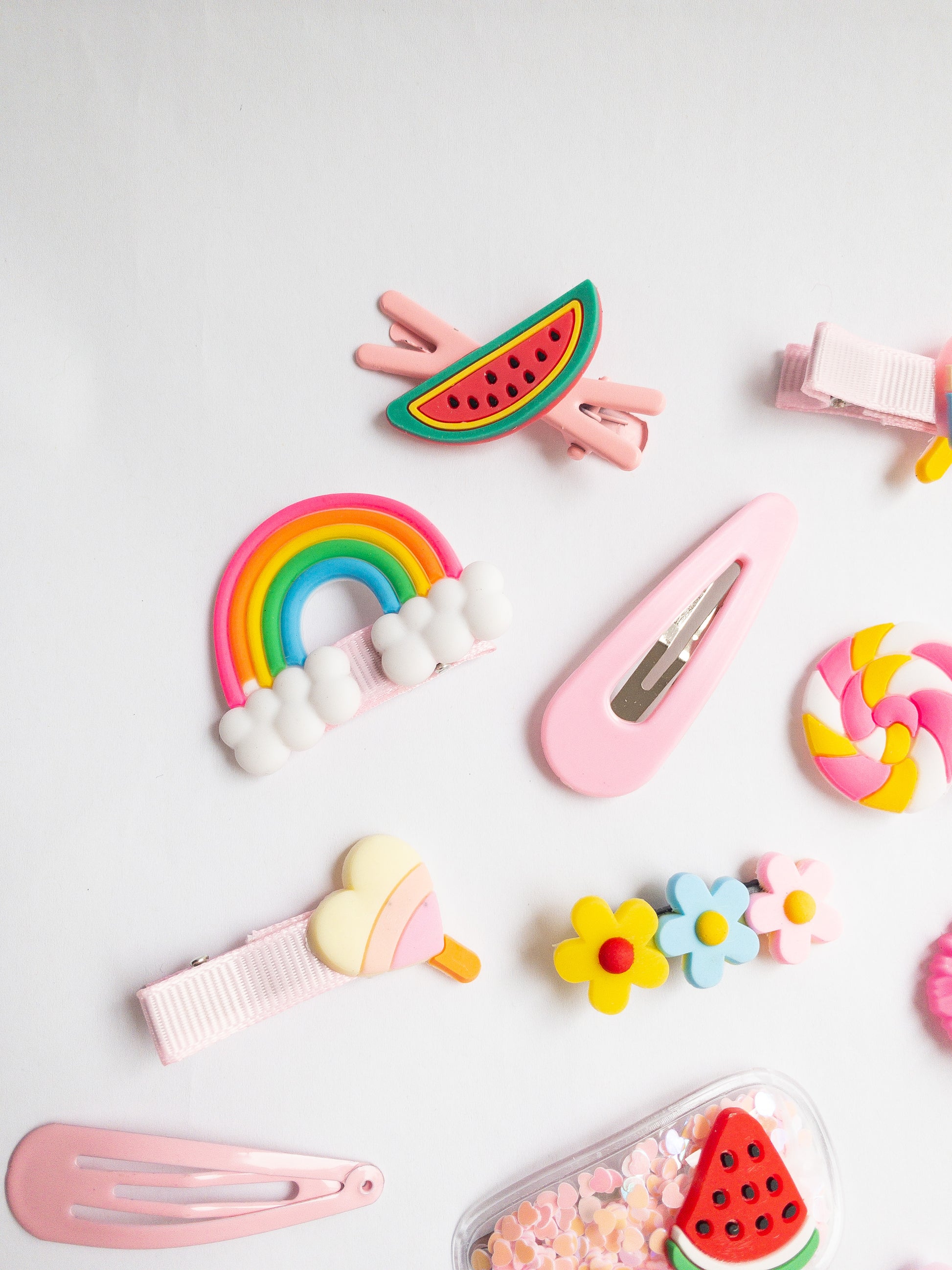 It's THE summer hair clip set! This 14 piece collection has everything--watermelons, flowers, whimsical lollipops, a bright rainbow, a starfish, and a couple pink classics.
