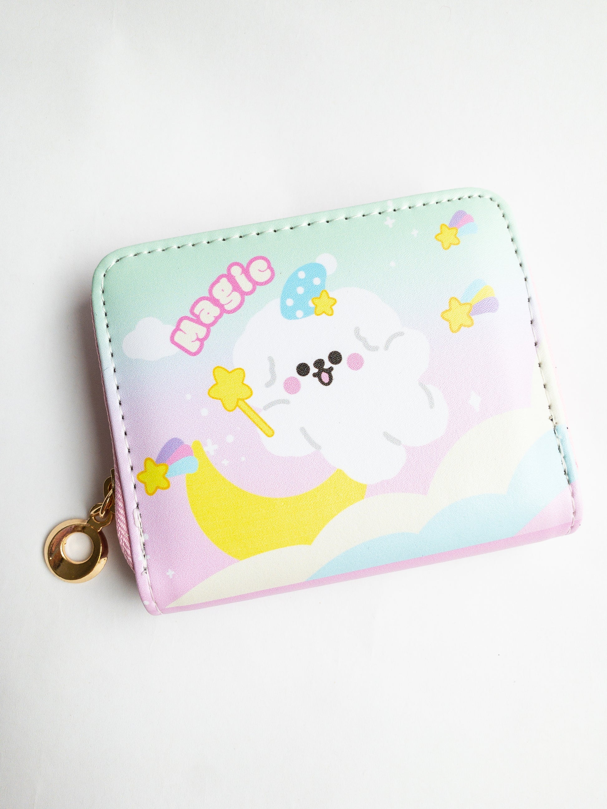 The Shooting Star Wallet! A magical little fluffy dog soars through a pastel rainbow sky with shooting stars. A playful zip close wallet with card slots and a coin pocket in the center, it’s perfect for keeping your small items organized! Reach for the stars with this compact wallet.