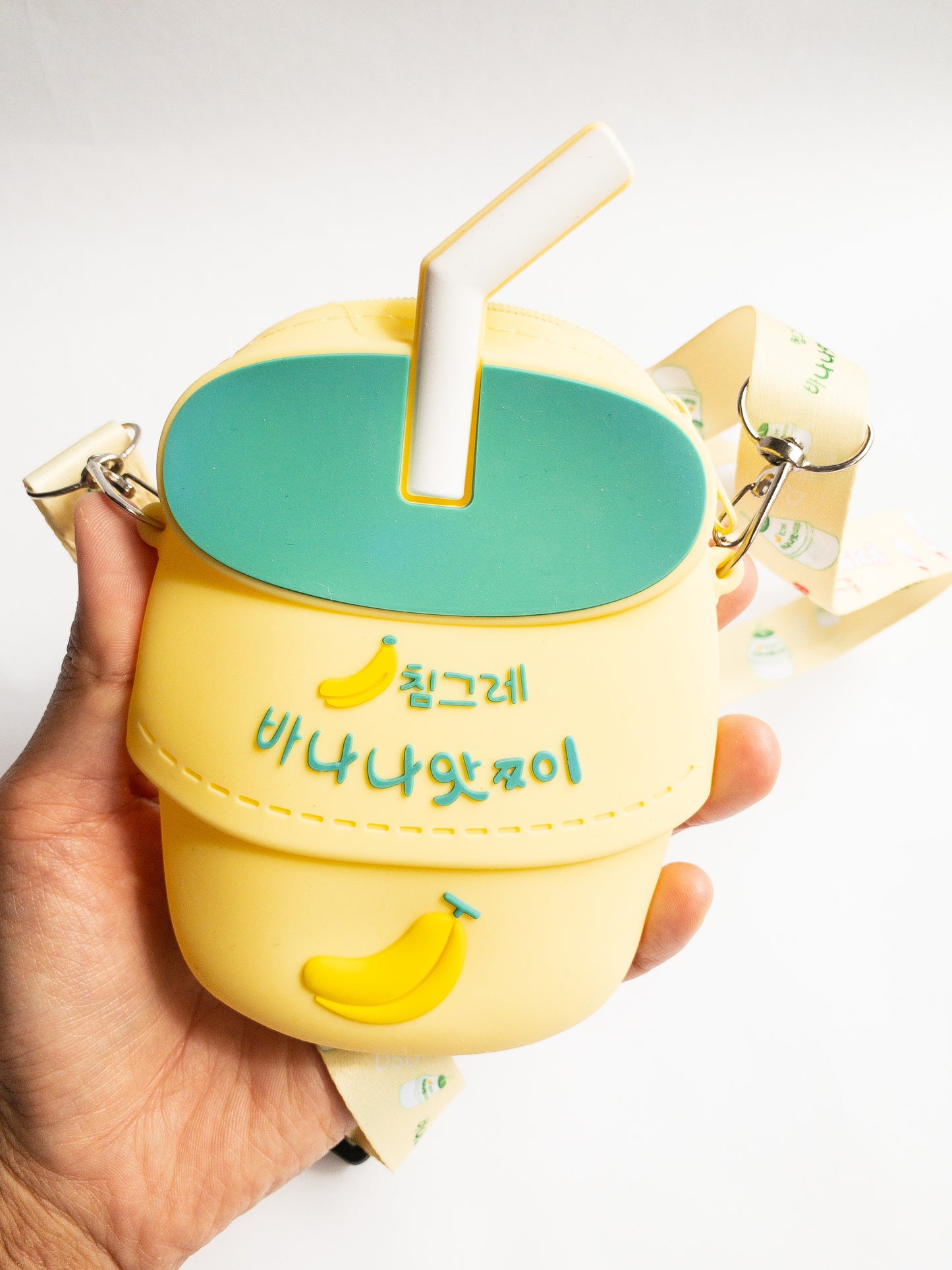 A bag shaped like your favorite childhood (and current!) beverage. This banana milk shaped bag is made of smooth silicone. It has one zip open with an adjustable fabric and removable strap. Sure to be a big hit!