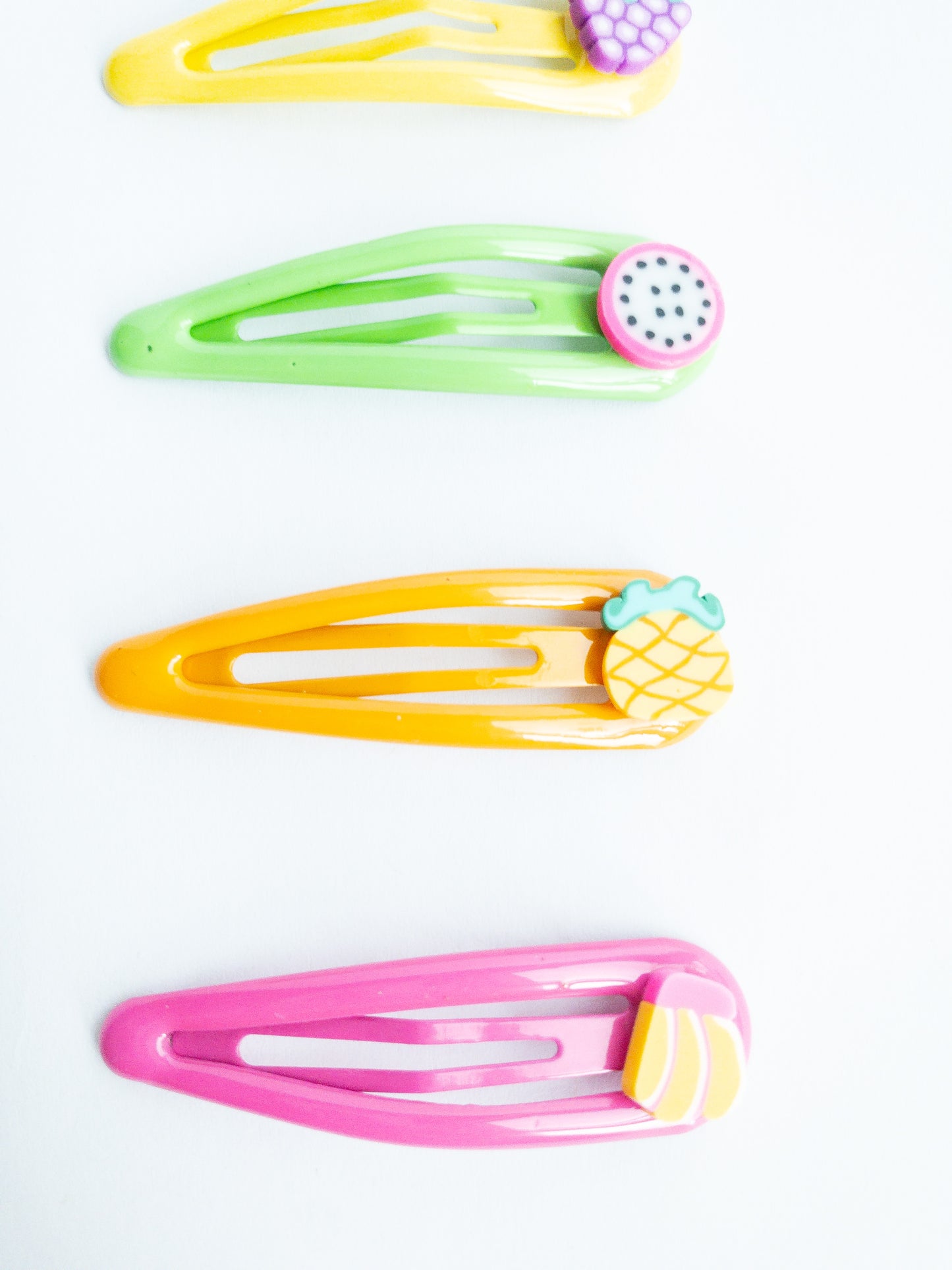 Add a sweet touch to your look with our adorable Little Fruits Hair Clips! These colorful clips come in a variety of fruit shapes and colors to brighten up any 'do. There's a dragon fruit, grapes, banana, cherry, and pineapple.