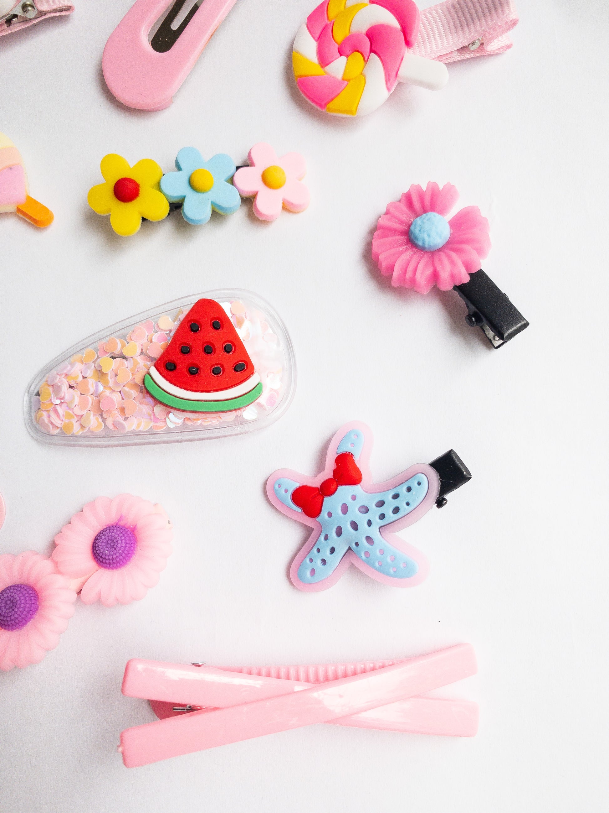 It's THE summer hair clip set! This 14 piece collection has everything--watermelons, flowers, whimsical lollipops, a bright rainbow, a starfish, and a couple pink classics.