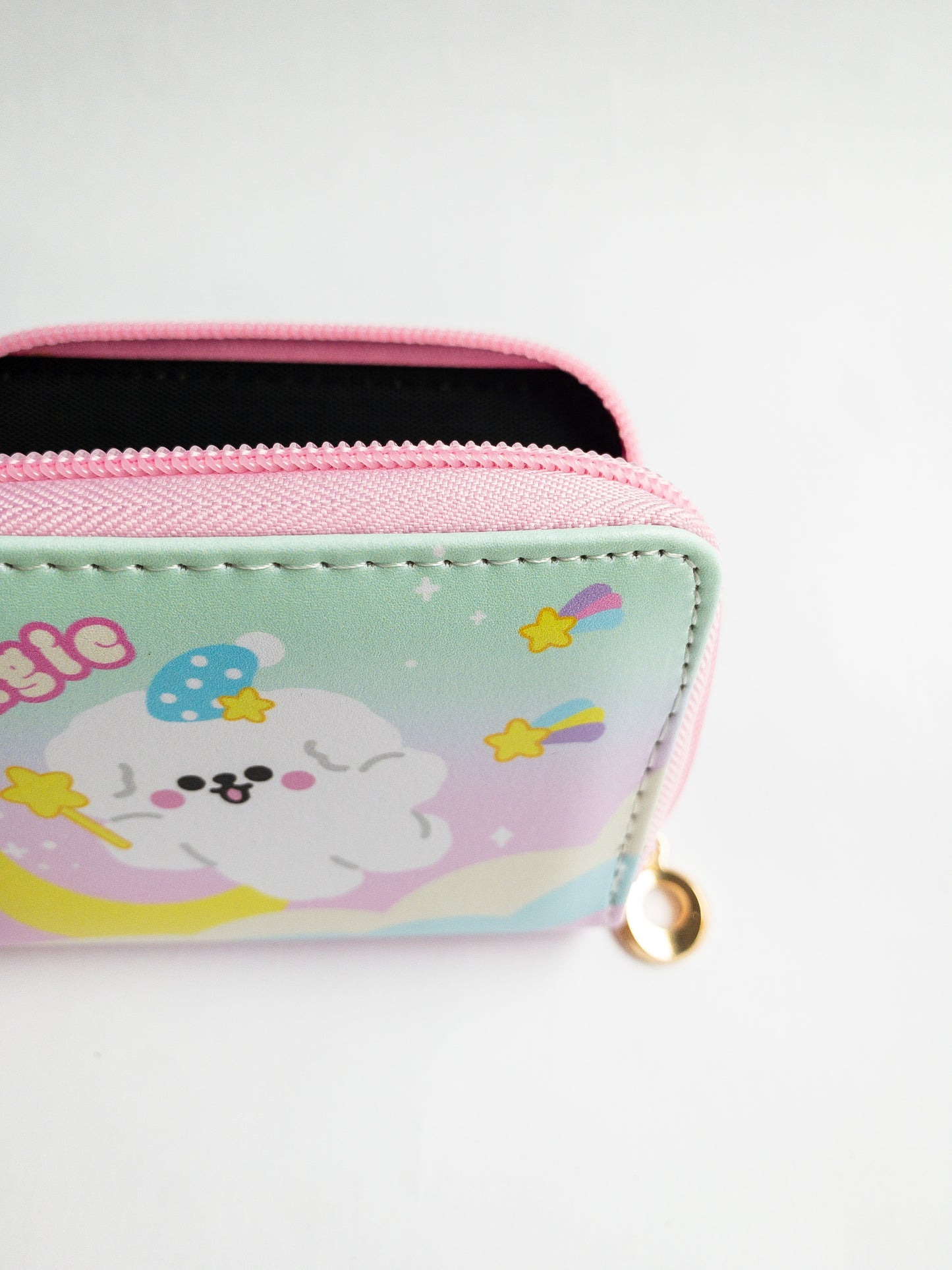 The Shooting Star Wallet! A magical little fluffy dog soars through a pastel rainbow sky with shooting stars. A playful zip close wallet with card slots and a coin pocket in the center, it’s perfect for keeping your small items organized! Reach for the stars with this compact wallet.