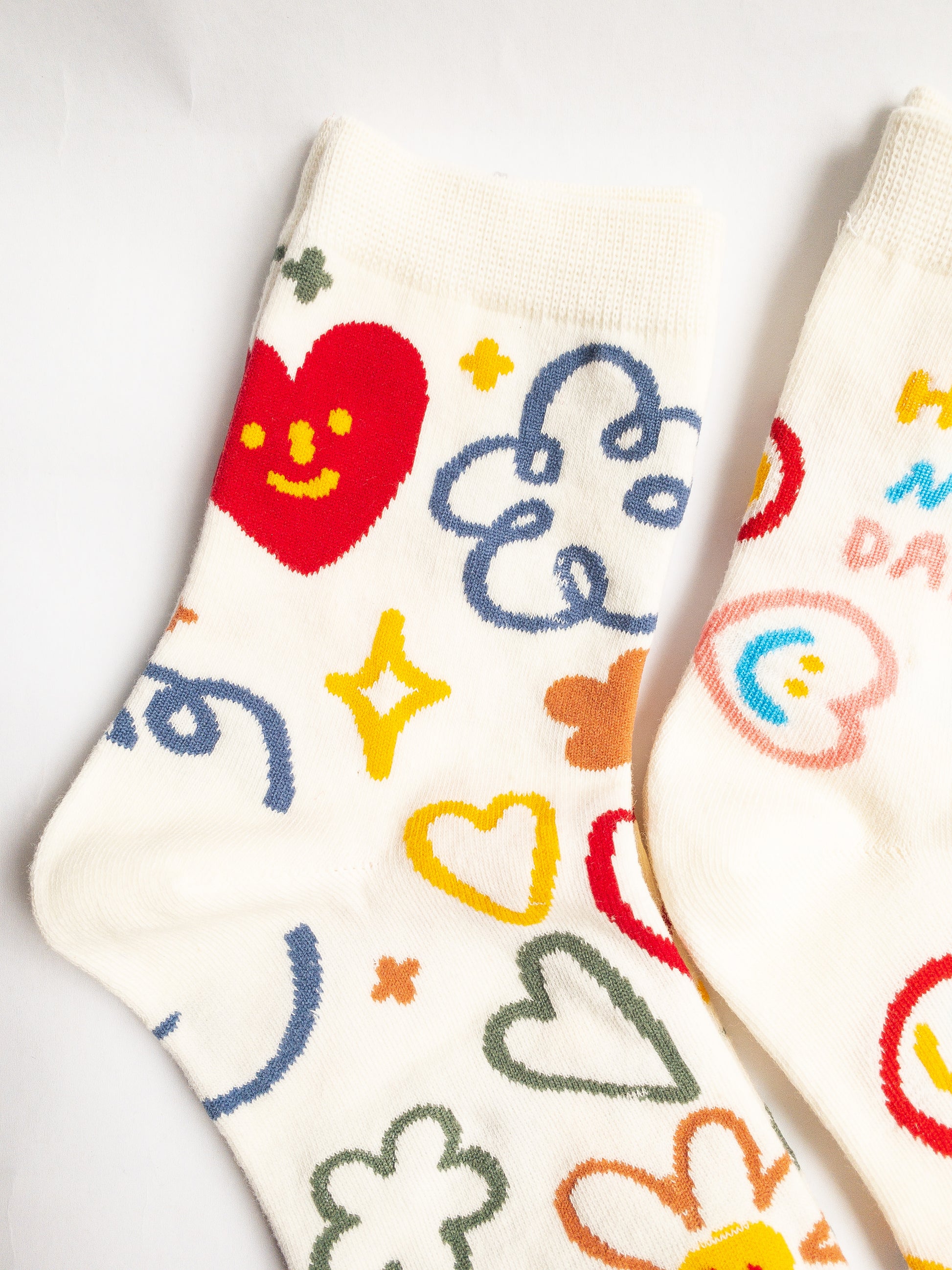 Playful and doodly Have a Nice Day socks! These thick, cozy, and comfortable crew socks feature a cheerful doodle smiley face and flower design, sure to put a smile on your face and a spring in your step every day. 