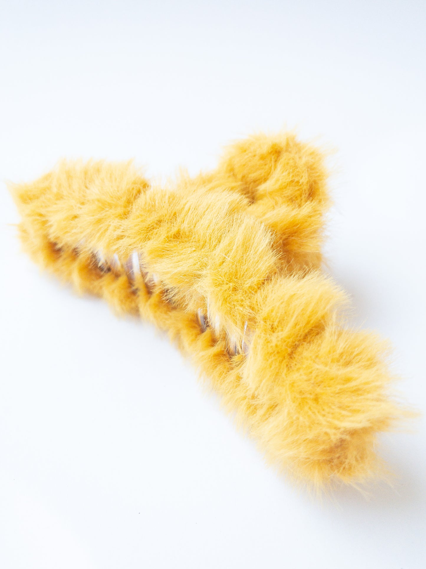 Just pure softness in a hair claw. Each transparent loop hair claw is wrapped in a furry soft yellow fabric for those easy to grab, messy hair days.