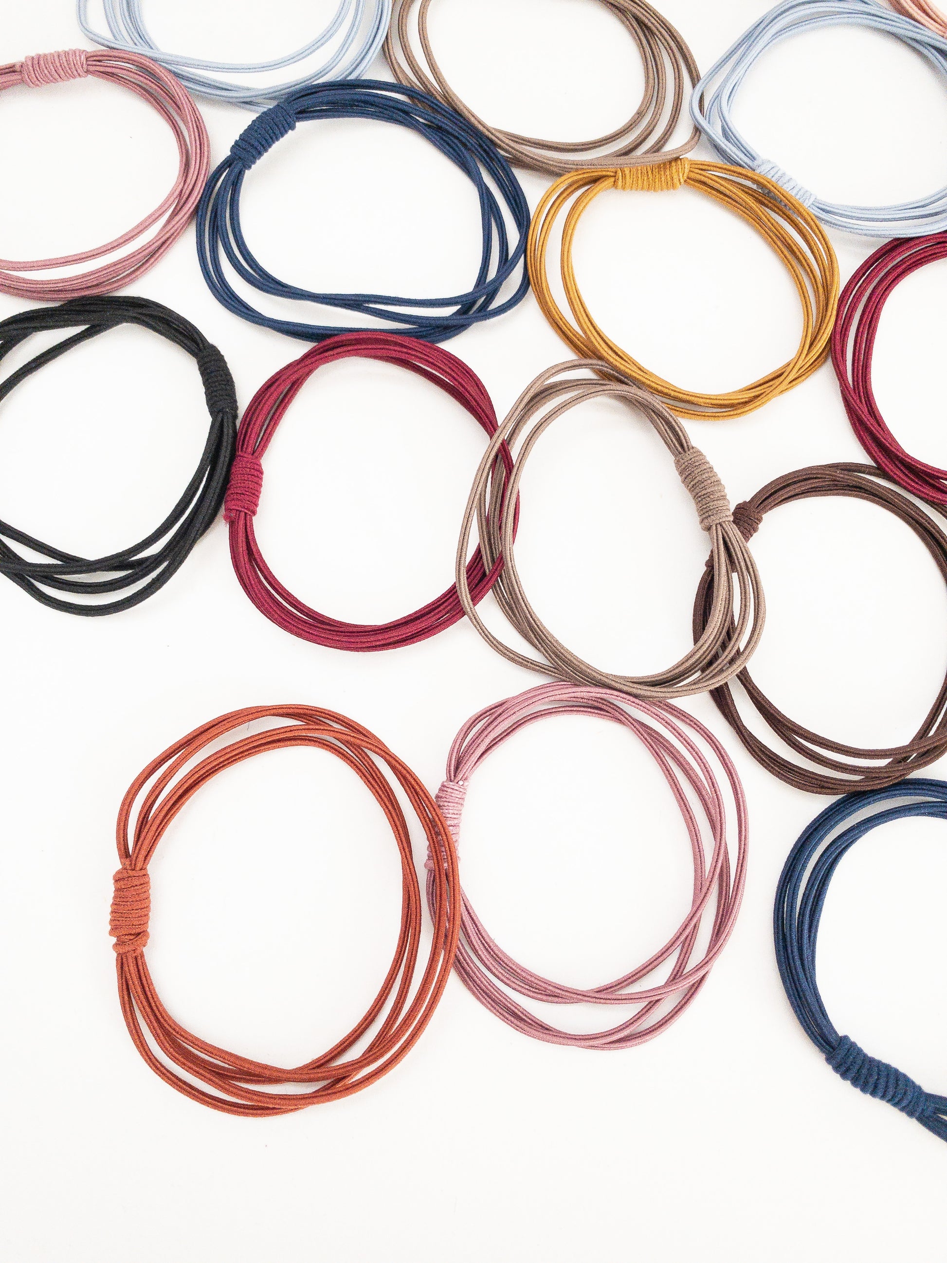 A much needed set of 20 hair ties! Each hair tie has four strands wrapped around and tied with a pretty coil. There are two of each color: black, plum, mustard, light pink, navy, dark brown, mauve, light blue, gray, and copper. Korean hair ties, Korean hair accessories, Korean accessories, Korean hair rubber bands