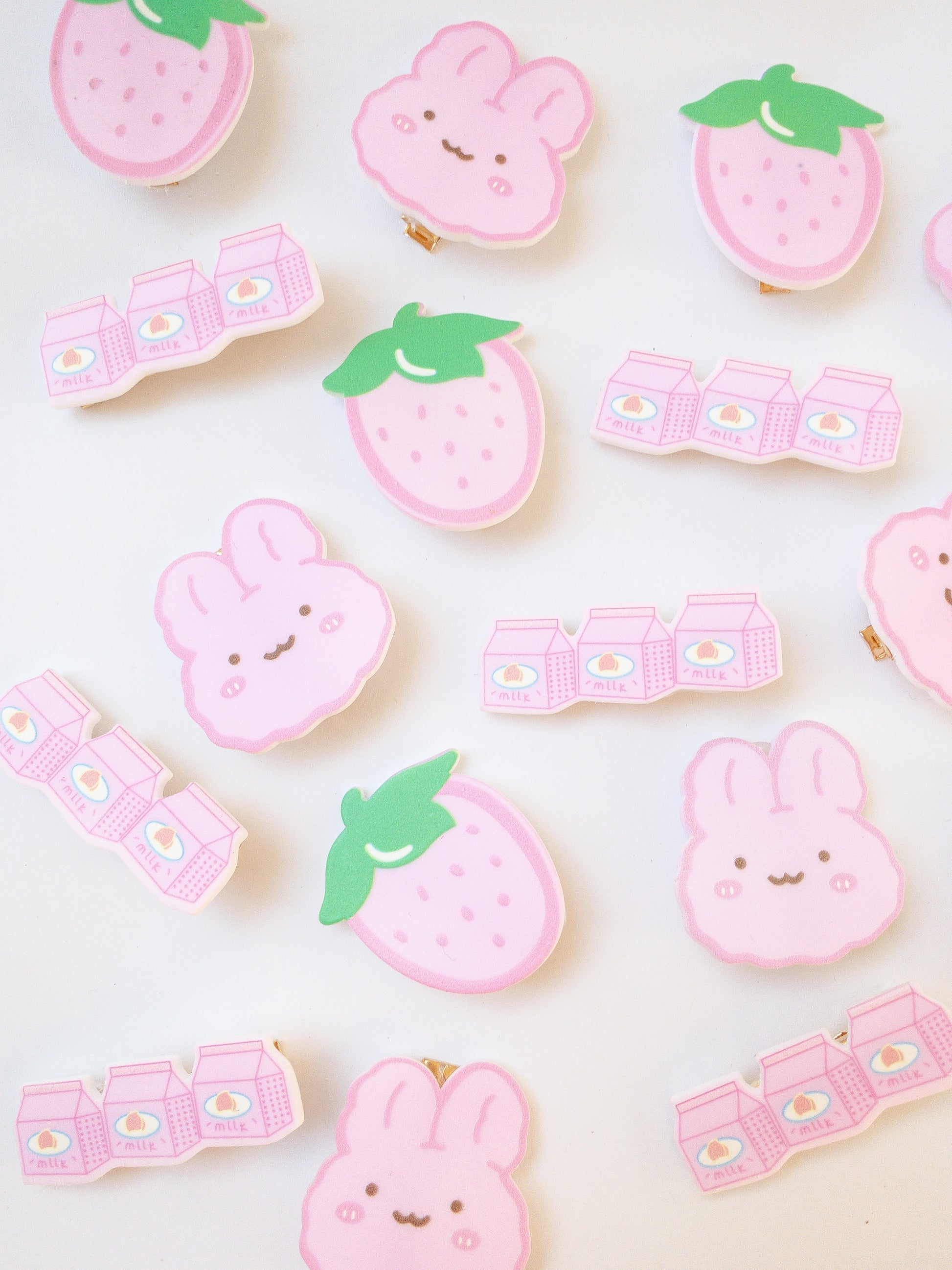 A set of 3 pink hair clips in the sweetest shapes. A pink fluffy cartoon bunny, a big juicy strawberry, and a trio of strawberry milks.  Gold alligator clips