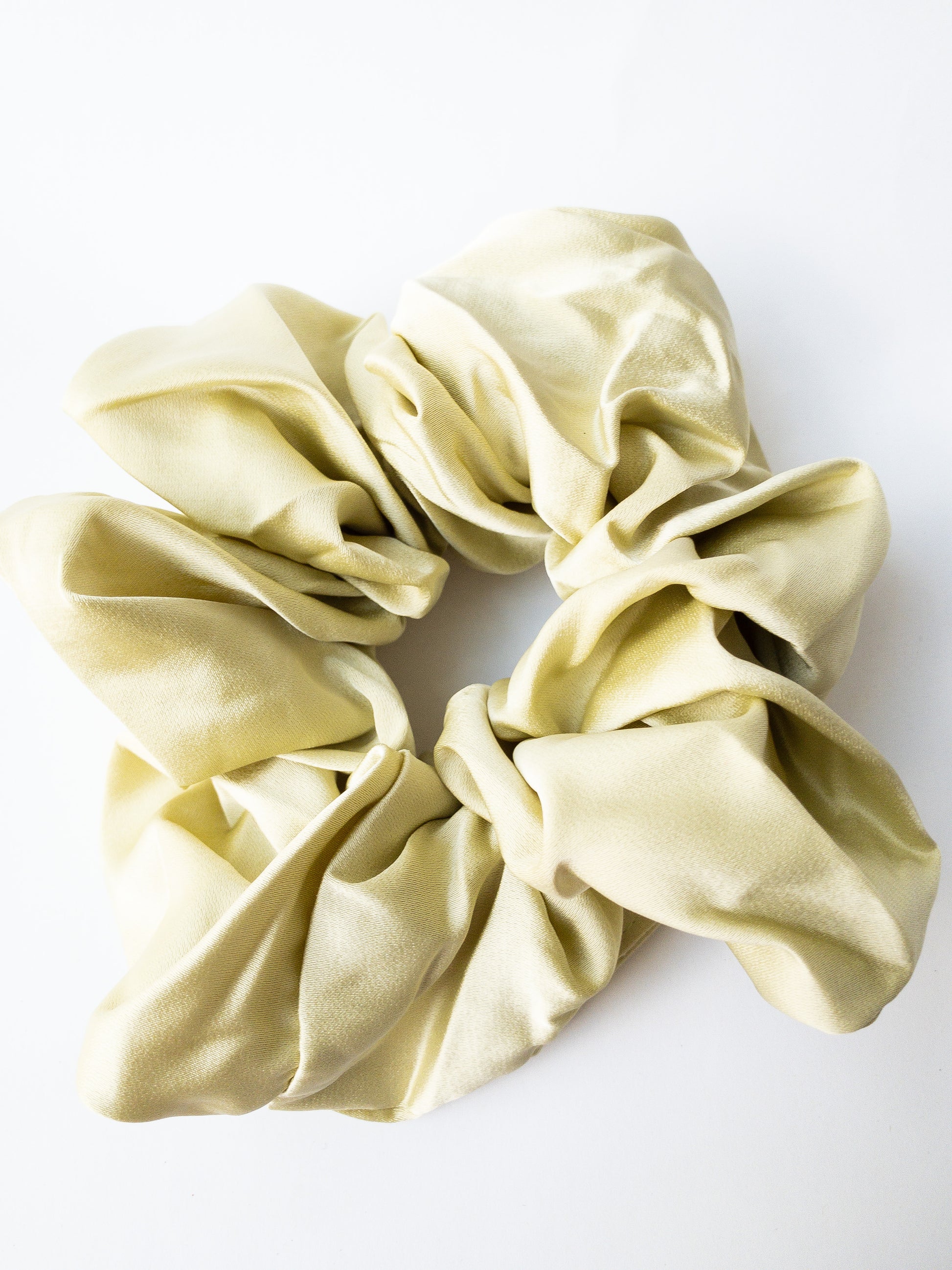 Rich and buttery soft jumbo oversized scrunchie in a beautiful sage green sheen. Perfect for holding curls and easily creating a romantic hairstyle. 
