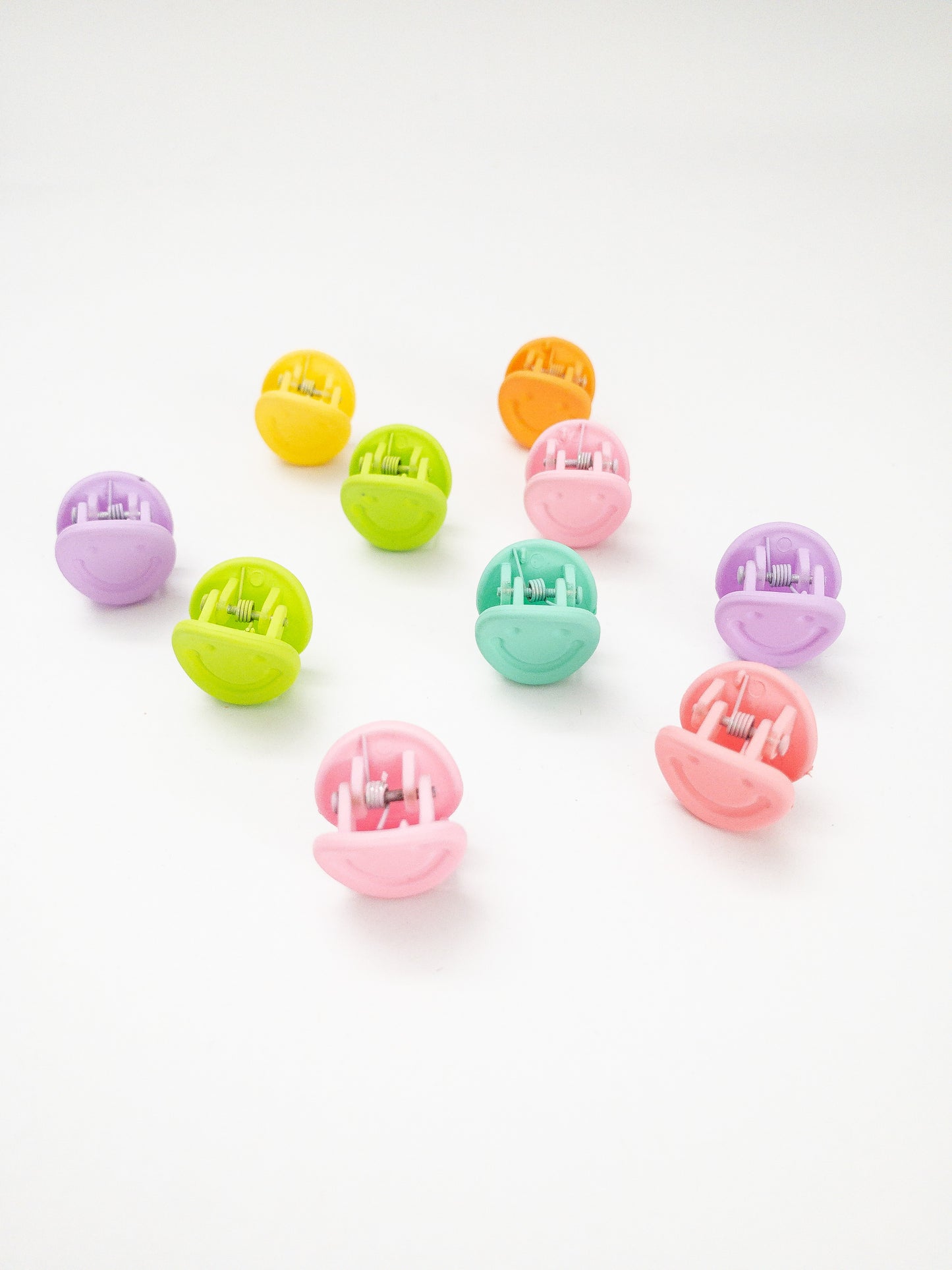 A 10-pack assortment of happy little smiley face hair claws. These are not mini sized but a little bigger at .75" in length. They're strong and stay in place and come in a variety of pretty frosted colors. Korean hair accessories, Korean accessories, Korean mini hair clips, Korean hair clips, Korean style hair accessories