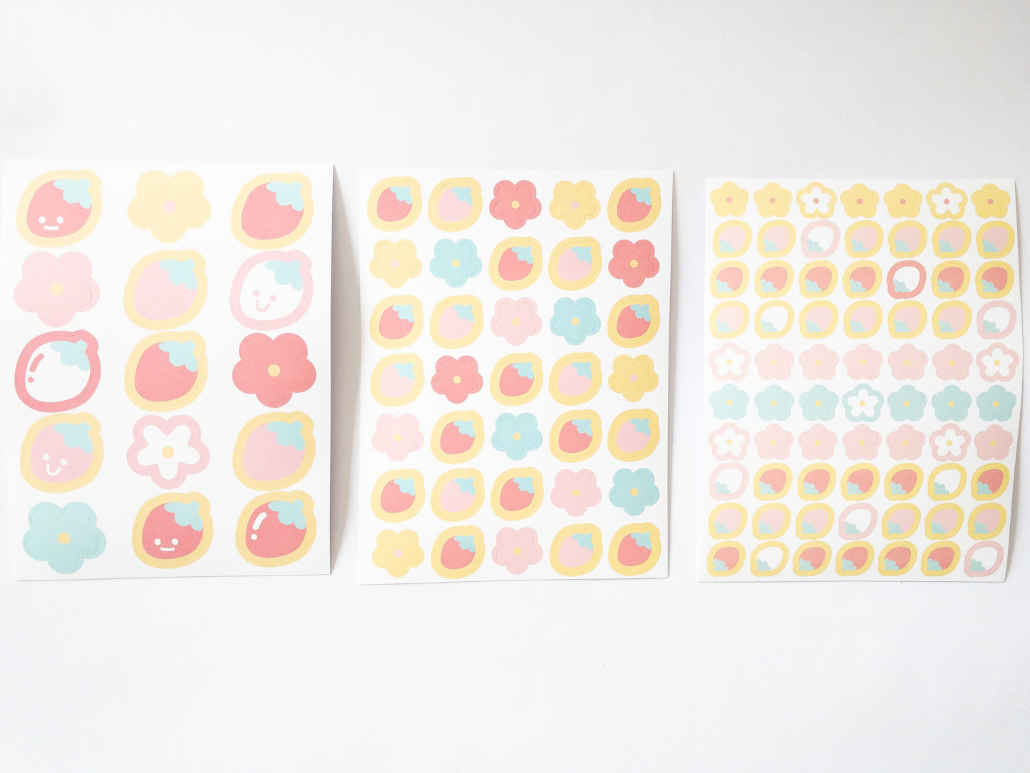 120 Korean style stickers! Three sheets of berry floral goodness. There are 70 mini flowers and strawberries, 35 medium-sized stickers and 15 large happy, smiley strawberries and flowers.
